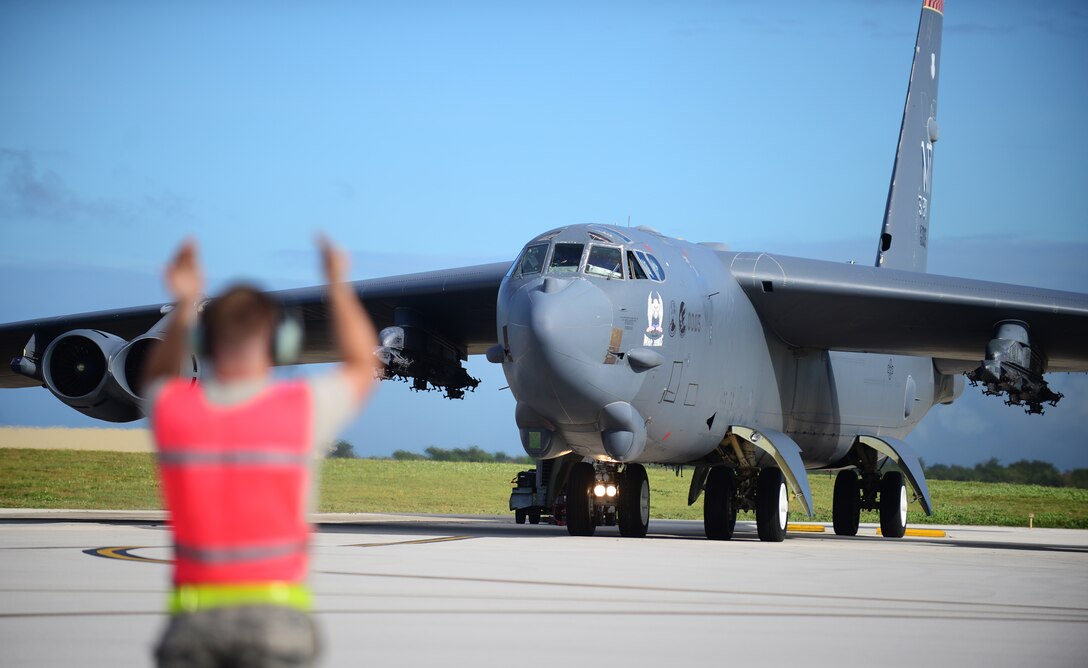 Airman 1st Class C.J. Rastetter, 36th Expeditionary Aircraft Maintenance Squadron crew chief, marshals a B-52 Stratofortress March 21, 2016, at Andersen Air Force Base, Guam. The U.S. conducts continuous bomber presence operations as part of a routine, forward deployed, global strike capability supporting regional security and our allies in the Indo-Asia-Pacific region. (U.S. Air Force photo by Senior Airman Joshua Smoot/Released)