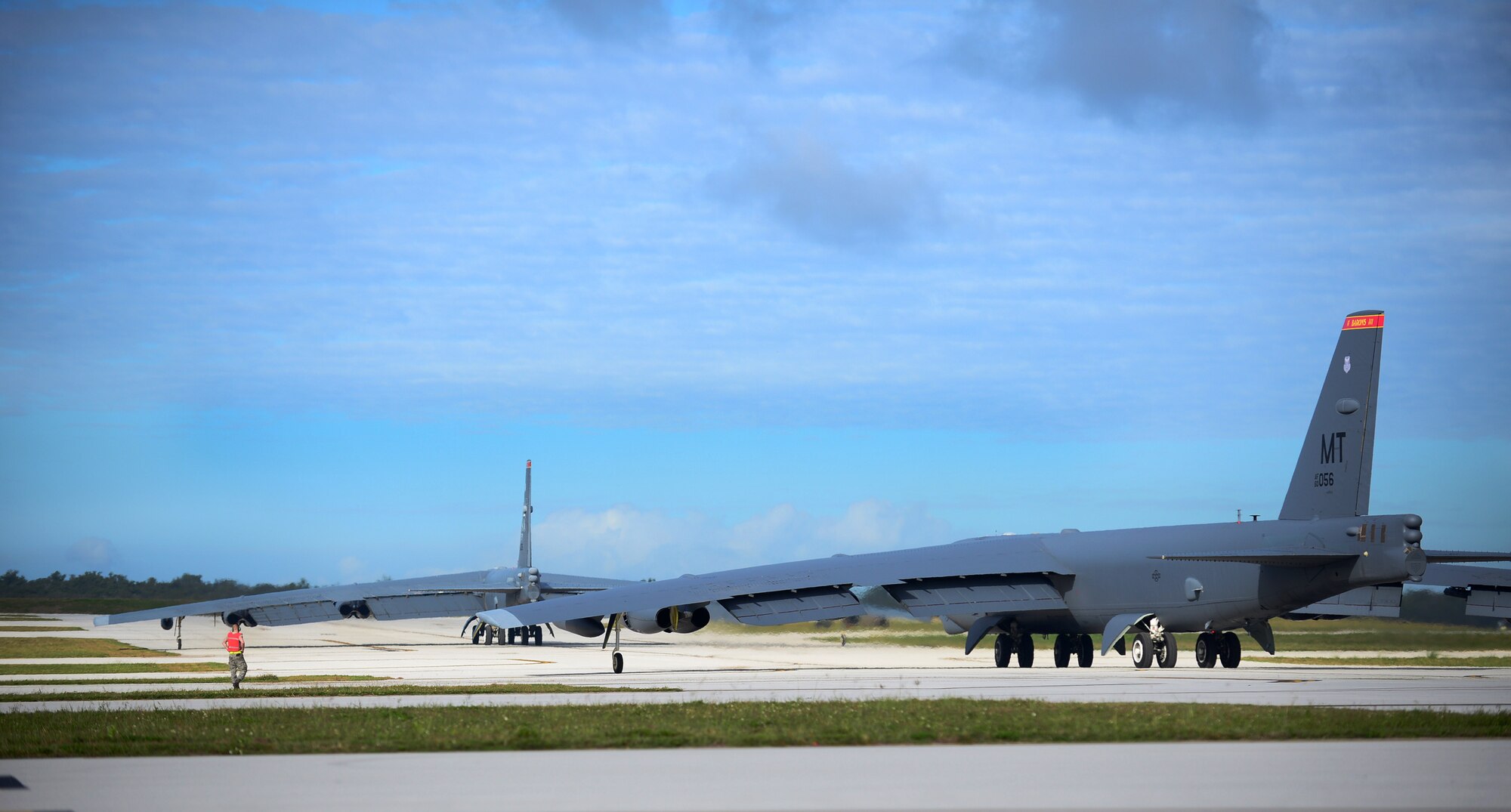 Two B-52 Stratofortresses taxi on the runway March 21, 2016, at Andersen Air Force Base, Guam. The U.S. military has maintained a deployed strategic bomber presence in the Pacific since March 2004, which has contributed significantly to regional security and stability. (U.S. Air Force photo by Senior Airman Joshua Smoot/Released)