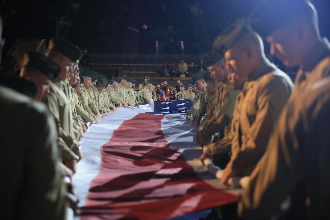 Marines with Marine Corps Communication-Electronics School unravel the National Colors during the 14th annual Banque Nationale de Paris Paribas Open’s Salute to Heroes at the Indian Wells Tennis Garden in Indian Wells, California, March 11, 2016. Prior to the start of the match, Marines enjoyed a free meal from a food stand of their choice, where many attendees of the open stopped and thanked them for their service.