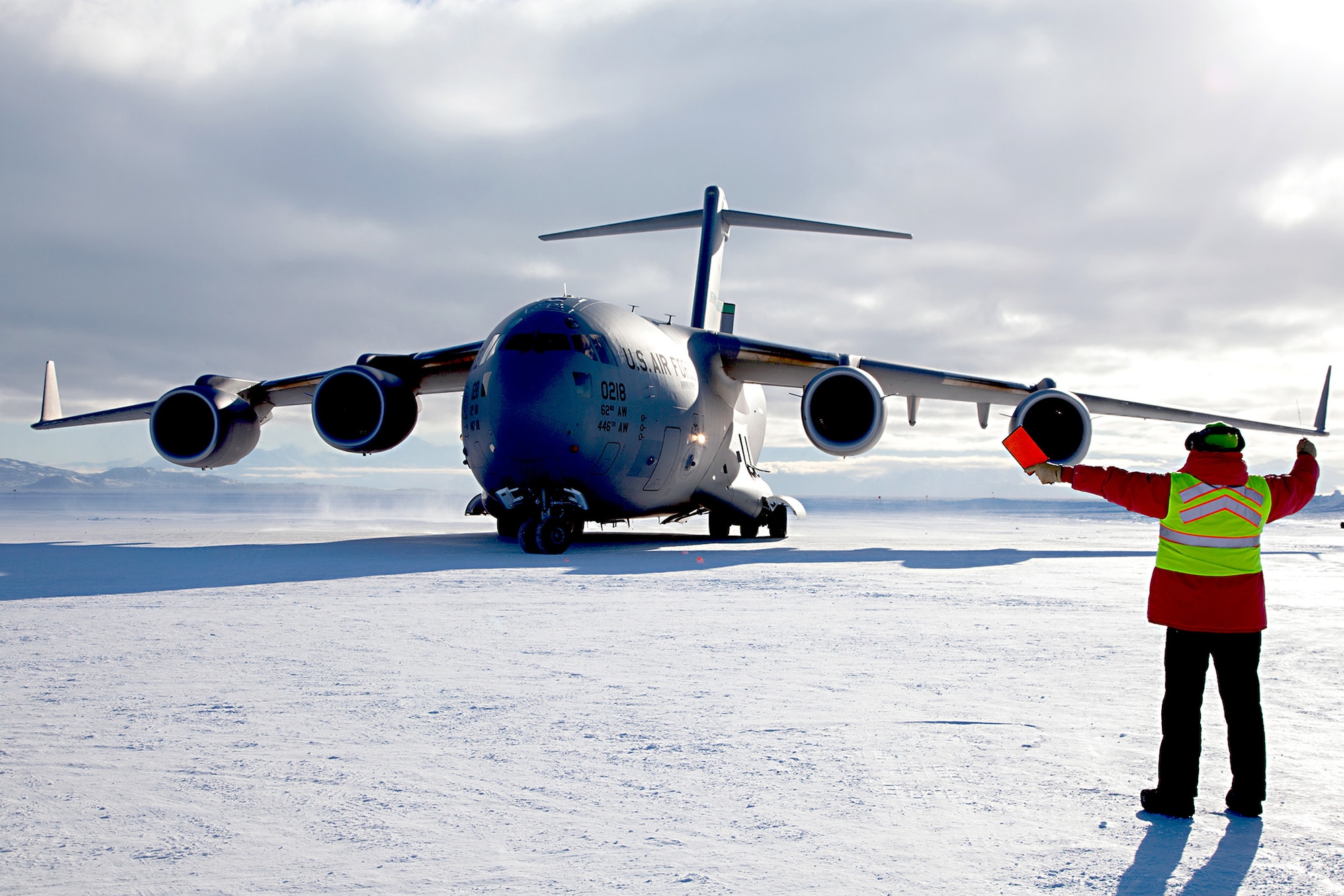 A C-17 Globemaster III aircraft out of Joint Base Lewis-McChord, Washington, is marshaled on Pegasus Runway, Antarctica during the 2015 Operation Deep Freeze Season. The 446th Airlift Rainier Wing partners with its sister unit, the 62nd Airlift Wing, in a total force Team McChord effort to provide airlift support to the Antarctic Program, which manages three research stations year round. (Courtesy photo)