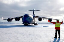 A C-17 Globemaster III aircraft out of Joint Base Lewis-McChord, Washington, is marshaled on Pegasus Runway, Antarctica during the 2015 Operation Deep Freeze Season. The 446th Airlift Rainier Wing partners with its sister unit, the 62nd Airlift Wing, in a total force Team McChord effort to provide airlift support to the Antarctic Program, which manages three research stations year round. (Courtesy photo)