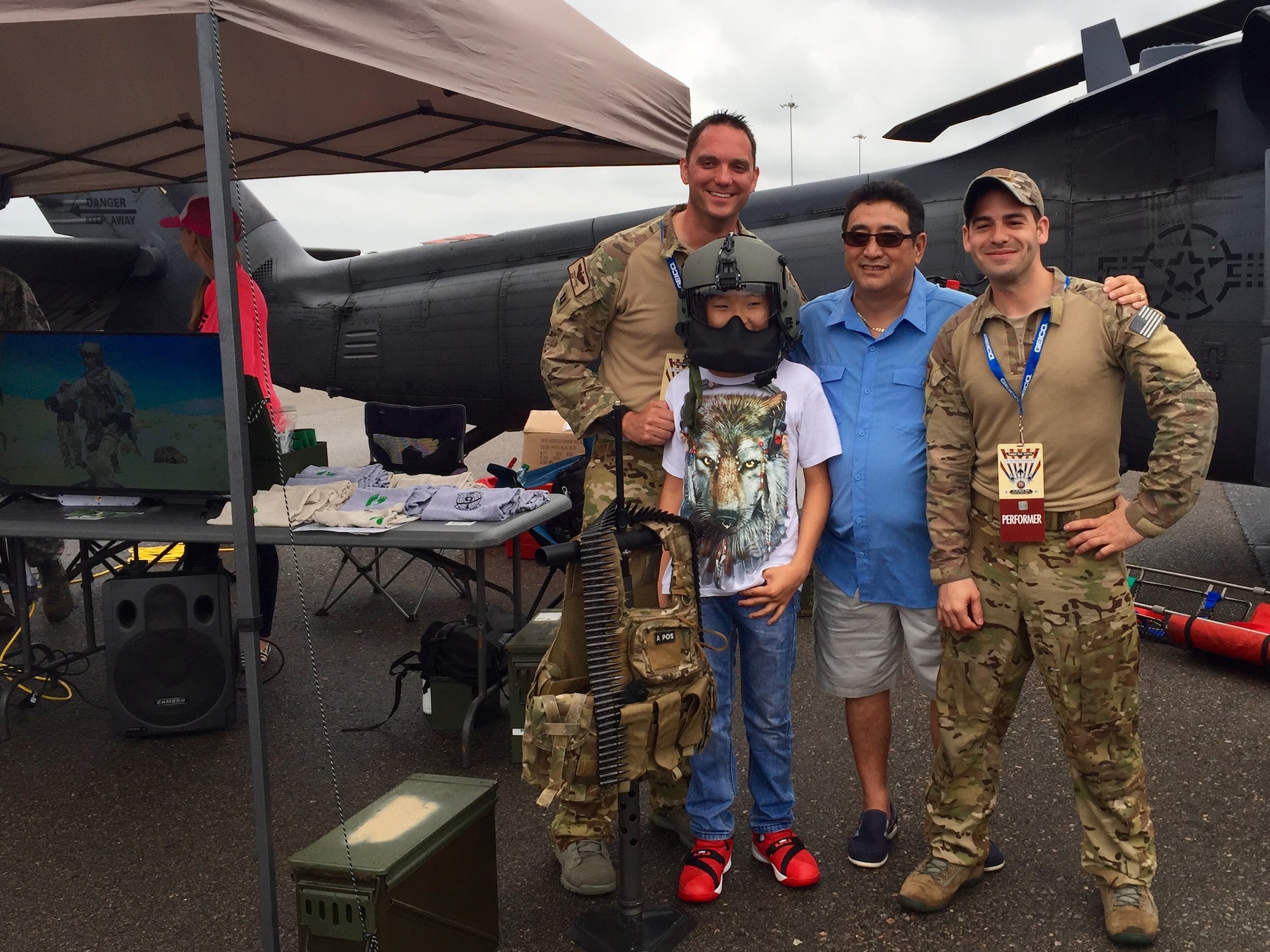 Reservists from the 920th Rescue Wing, Patrick Air Force Base, Fla., pose with visitors in front of an HH-60G Pave Hawk helicopter static display during an air show at MacDill Air Force Base, Fla., March 19, 2016. Six 920th Airmen supported the display at MacDill's AirFest, which is held every other year. (U.S. Air Force photo by 2nd Lt. Anna-Marie Wyant)