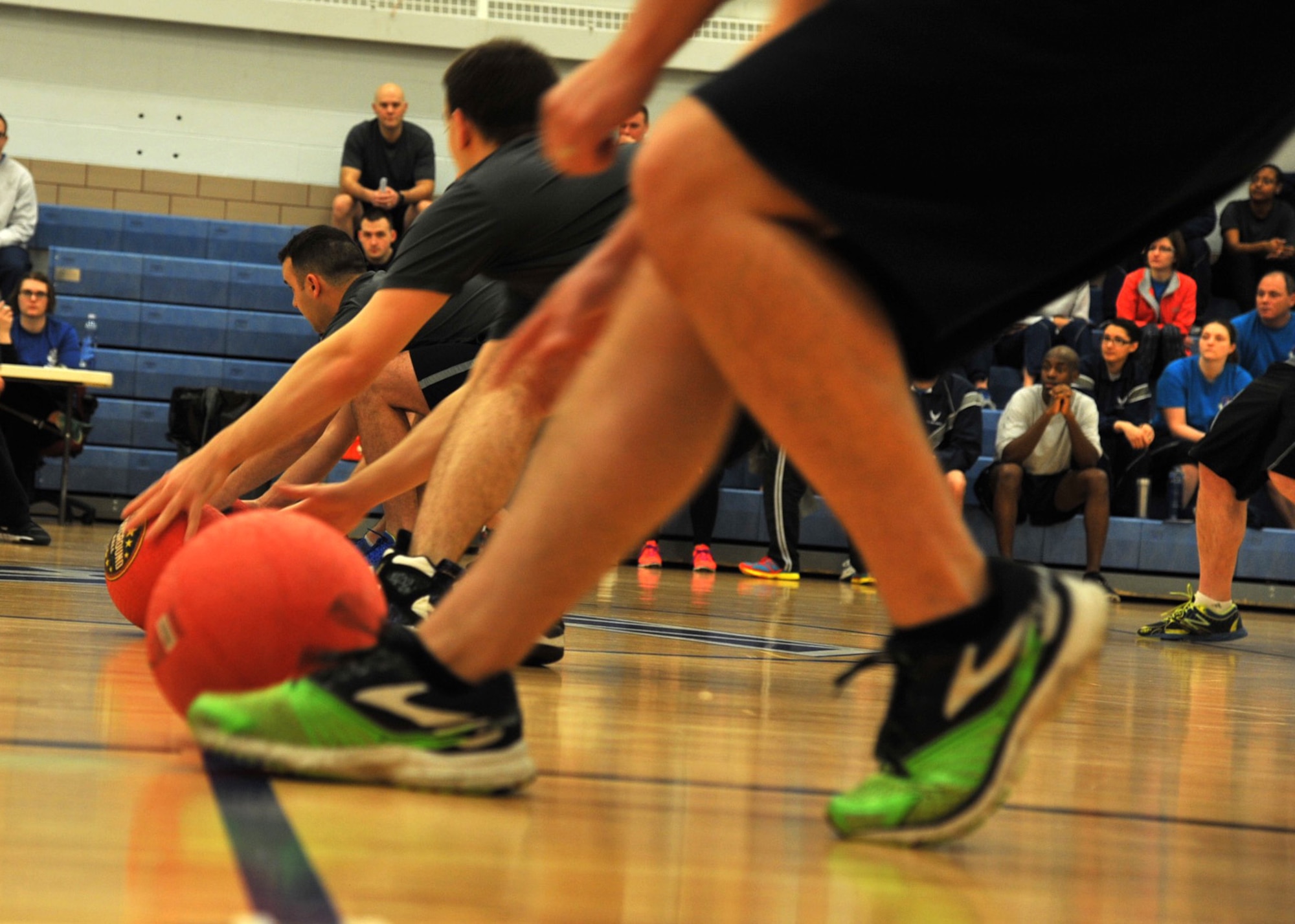 Airmen from the 319th Air Base Wing reach for dodge balls March 18, 2016, on Grand Forks Air Force Base, N.D. Squadrons competed against each other in many sports to include a dodge ball tournament during the 2016 Winter Bash. (U.S. Air Force photo by Airman 1st Class Patrick Wyatt/Released)