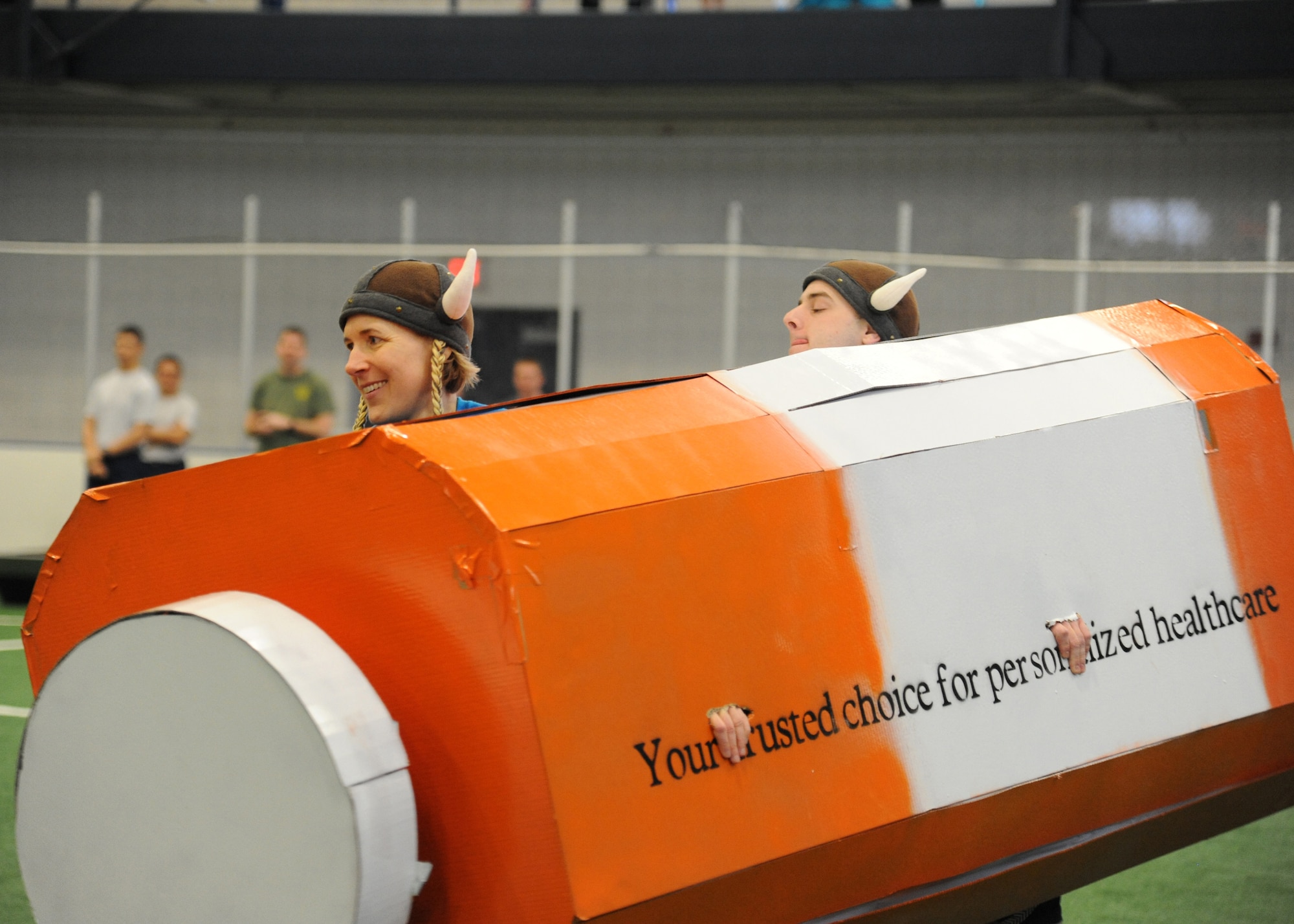 Lt. Col. Christine Campbell, 319th Medical Operations Squadron commander, left, and Airman 1st Class Ian Crump, 319th Medical Support Squadron biomedical equipment maintenance apprentice, compete in the 2016 Winter Bash boat race March 18, 2016, on Grand Forks Air Force Base, N.D. Each squadron was provided material to build a boat and competed for the best time in the course. (U.S. Air Force photo by Airman 1st Class Ryan Sparks/Released)