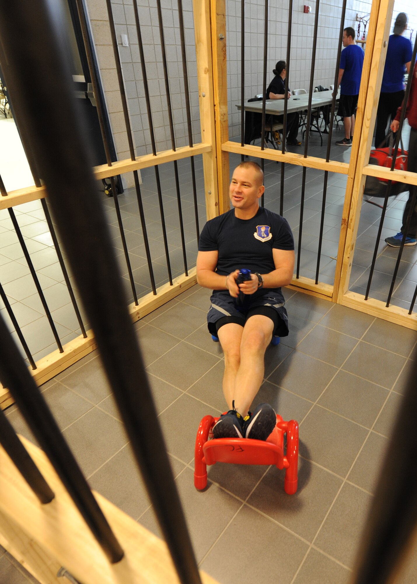 Chief Master Sgt. Todd Krulcik, 319th Air Base Wing command chief, relaxes in jail during the 2016 Winter Bash March 18, 2016, on Grand Forks Air Force Base, N.D. The 319th Security Forces Squadron morale club allowed Airmen to pay to have their friends imprisoned in the Jail-N-Bail to raise money for future events. (U.S. Air Force photo by Airman 1st Class Ryan Sparks/Released)
