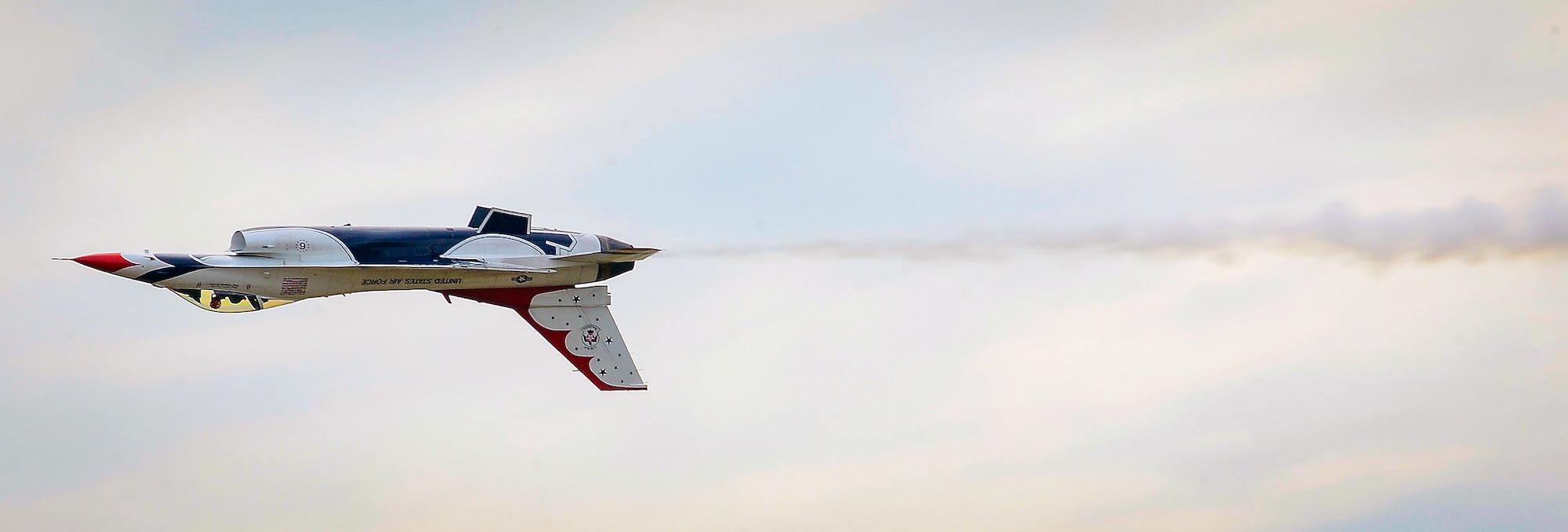 U.S. Air Force Thunderbird Number 6 flies by the audience inverted at Tampa Bay AirFest 2016 at MacDill Air Force Base, Fla., March 20, 2016. The Thunderbirds performed at Tampa Bay AirFest 2016 in front of more than 100,000 people over two days. (U.S. Air Force photo by Senior Airman Ned T. Johnston)