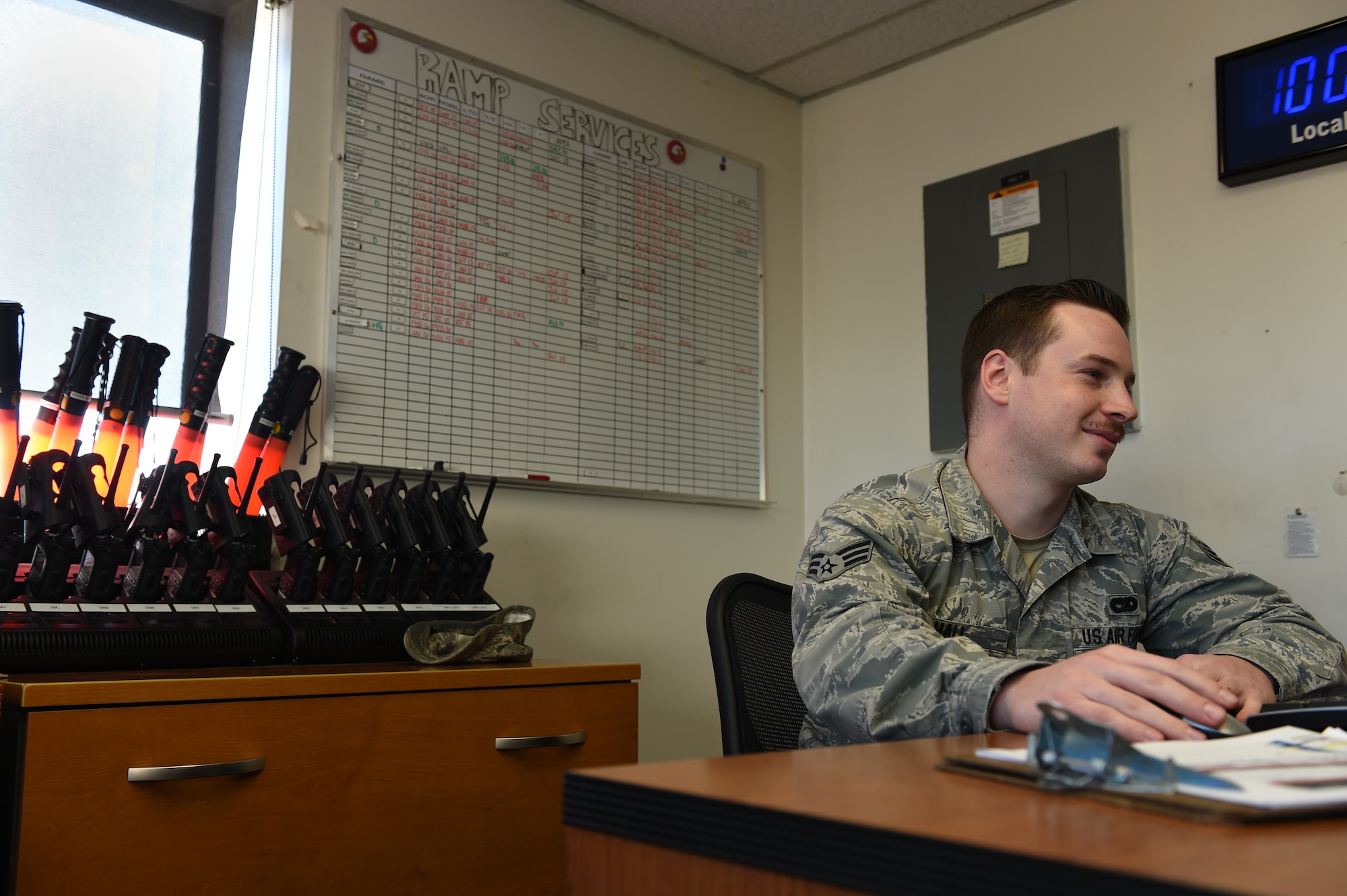 Senior Airman Christian Hall, 62nd Aerial Port Squadron ramp services journeyman, looks at his schedule in the ramp services section of the 62nd APS March 17, 2016, at Joint Base Lewis-McChord,Wash. The 62nd APS is currently providing support to the 610th Engineer Support Company missions going to Texas for border patrol support. (U.S. Air Force photo/Staff Sgt. Naomi Shipley)