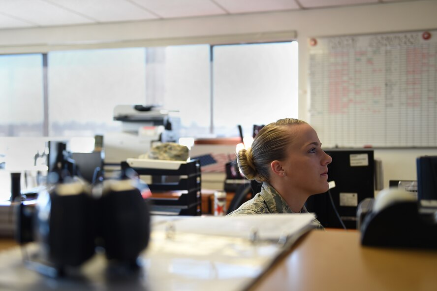 Senior Airman Jenna Kraus, 62nd Aerial Port Squadron ramp services journeyman, looks at scheduling notes in the ramp services section of the 62nd APS March 17, 2016, at Joint Base Lewis-McChord, Wash. Kraus and her section of the APS load and unload aircraft on McChord Field from anything to include cargo or personnel. (U.S. Air Force photo/Staff Sgt. Naomi Shipley)