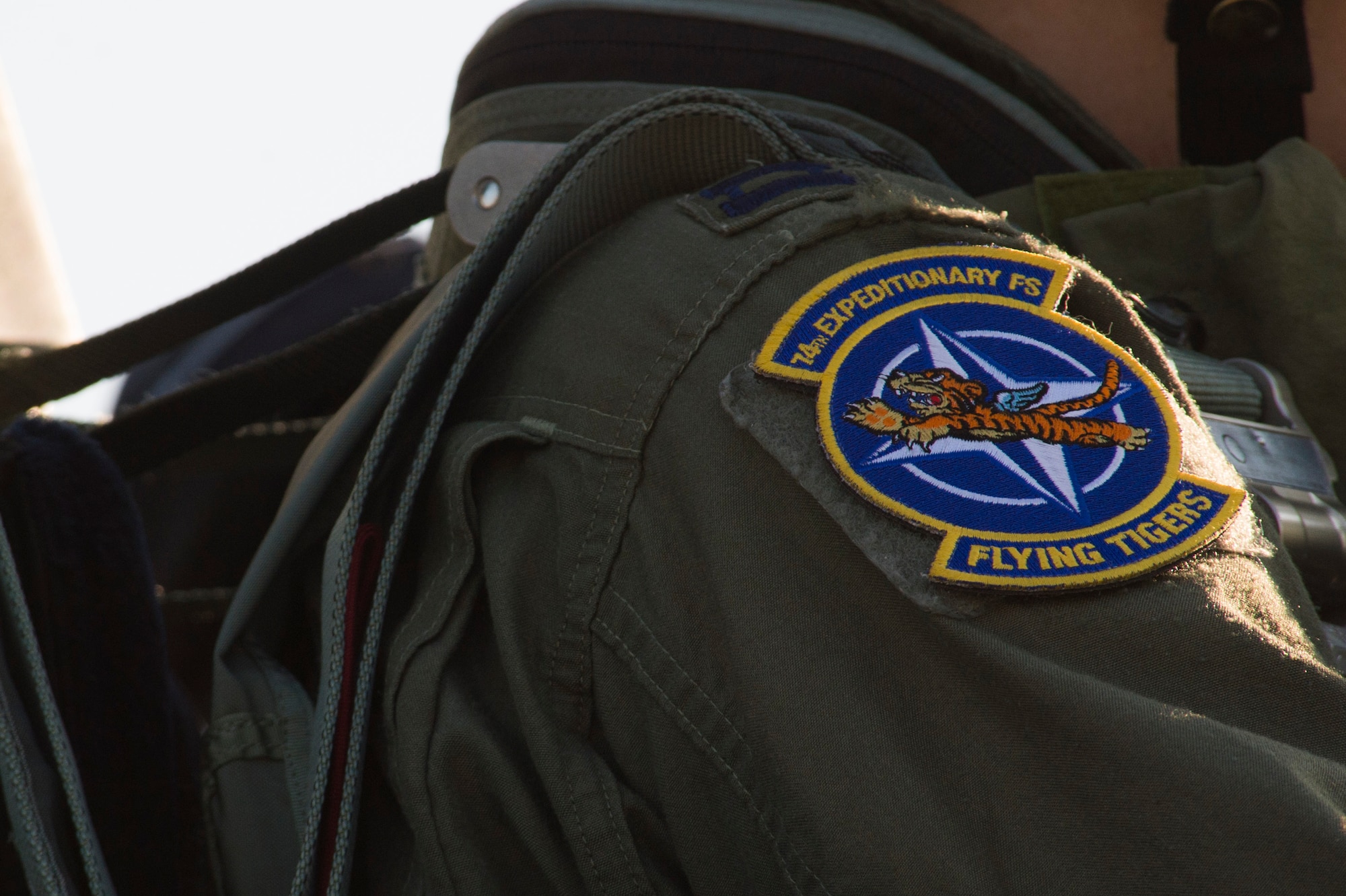A 74th Expeditionary Fighter Squadron patch is displayed on the shoulder of U.S. Air Force Capt. Chandra Fleming, a 74th EFS A-10 Thunderbolt II pilot, during the 74th EFS’s deployment in support of Operation Atlantic Resolve at Graf Ignatievo, Bulgaria, March 18, 2016. The patch incorporates the squadron’s legacy which dates back to the original ‘Flying Tigers’ who served in the Burma-Indo-China Theater during World War II. (U.S. Air Force photo by Staff Sgt. Joe W. McFadden/Released)