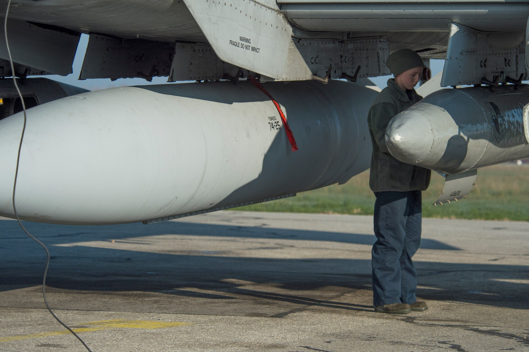 U.S. Air Force Airman 1st Class Felicia Anderson, a 74th Expeditionary Fighter Squadron crew chief, places equipment inside a storage compartment under the wing of a U.S. Air Force A-10 Thunderbolt II during the 74th EFS’s deployment in support of Operation Atlantic Resolve at Graf Ignatievo, Bulgaria, March 18, 2016. The A-10s represented a theater security package rotation, which began in the European theater in 2015 to reassure NATO allies and partner nations of the U.S.’s commitment to the security and stability of Europe. (U.S. Air Force photo by Staff Sgt. Joe W. McFadden/Released)