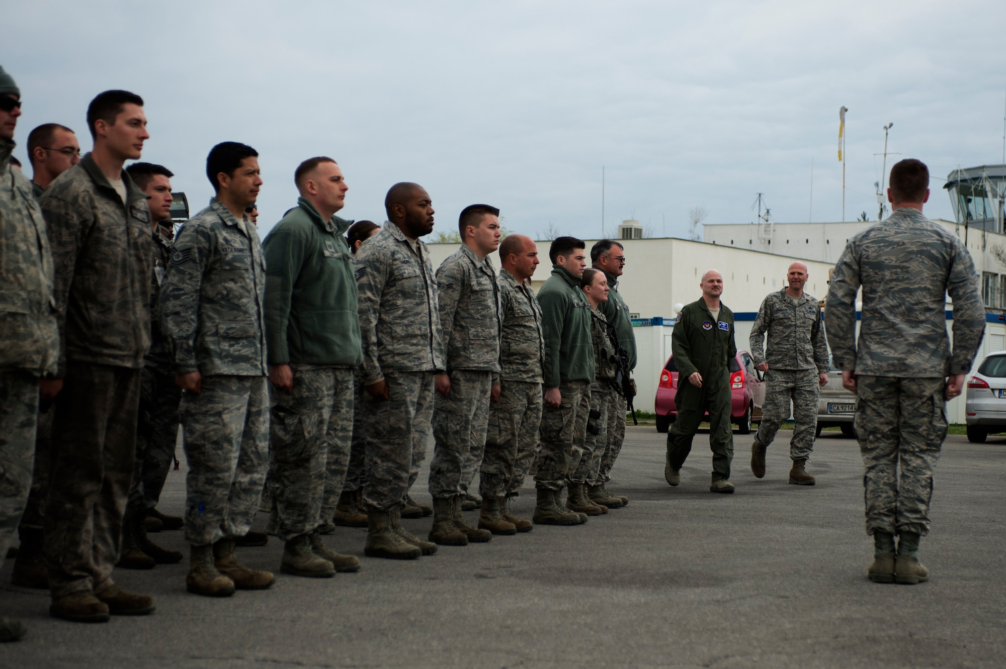 U.S. Air Force Lt. Col. Bryan France, 74th Expeditionary Fighter Squadron commander, center left, and Chief Master Sgt. Steven Cournoyer, 74th EFS chief enlisted manager, center right, walk to the front of a flight of mission support Airmen for a commander’s call during the 74th EFS’s deployment in support of Operation Atlantic Resolve at Graf Ignatievo, Bulgaria, March 16, 2016. The Airmen served in various communications, security forces, civil engineer, contracting, force support and logistics capacities to augment the 74th EFS’s six-month deployment to Eastern Europe. (U.S. Air Force photo by Staff Sgt. Joe W. McFadden/Released)