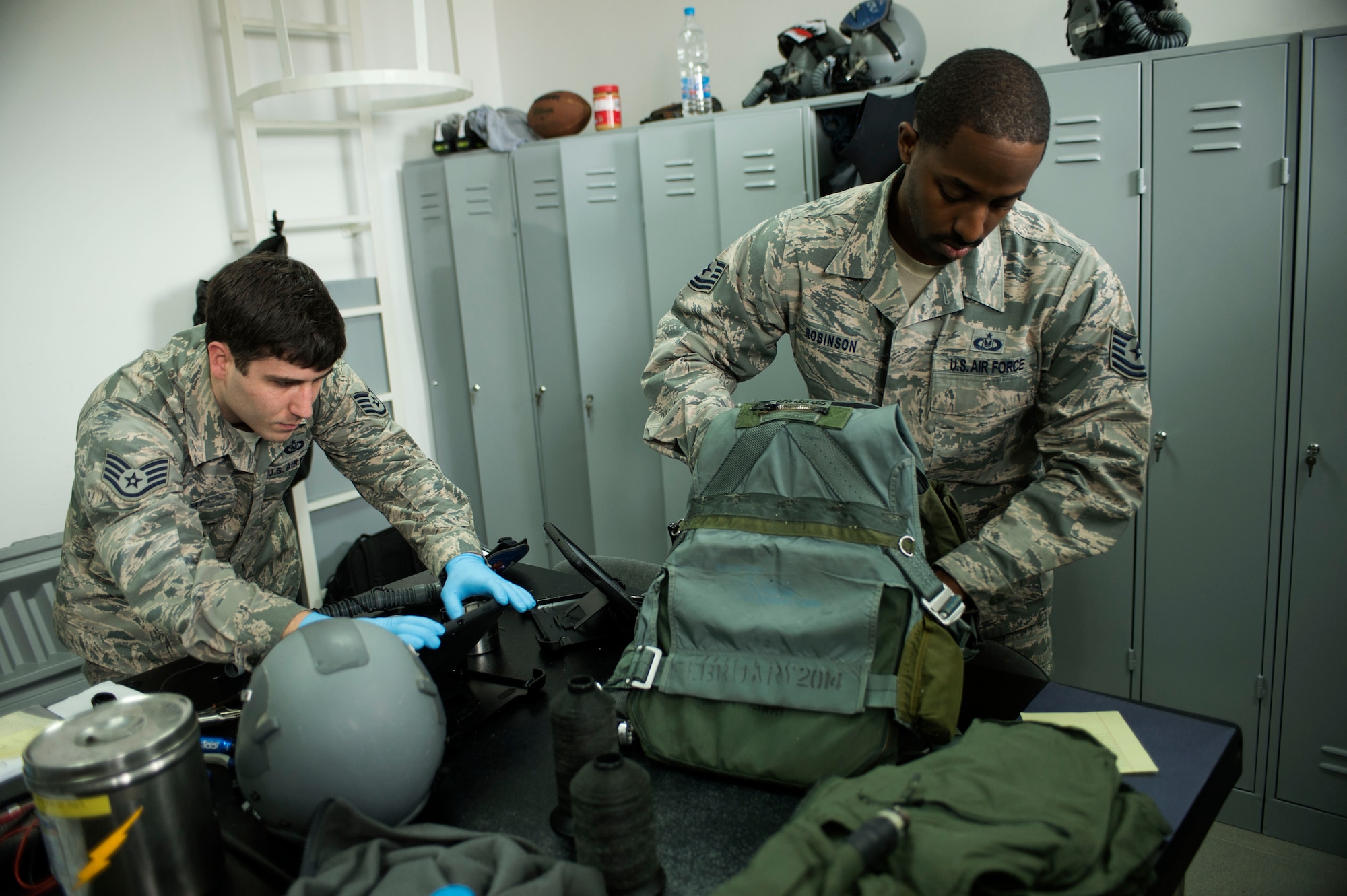 U.S. Air Force Staff Sgt. Kevin Ray, left, and Tech. Sgt. Nathanial Robinson Jr., right, both 74th Expeditionary Fighter Squadron aircrew flight equipment technicians from the 23rd Operations Support Squadron at Moody Air Force Base, Ga., check survival equipment during the 74th EFS’s deployment in support of Operation Atlantic Resolve at Graf Ignatievo, Bulgaria, March 16, 2016. Aircrew flight equipment technicians inspect and repair all gear issued before and after every flight. (U.S. Air Force photo by Staff Sgt. Joe W. McFadden/Released)
