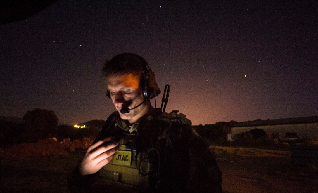 Senior Airman Tormod Lillekroken, 2nd Air Support Operations Squadron joint terminal attack controller, reviews training objectives as part of a night training scenario during Exercise Serpentex ‘16 in Corsica, France, March 15, 2016. Lillekroken recently reached his goal to be qualified as a joint terminal attack controller. Lillekroken has been in the tactical air control party career field for more than four years. (U.S. Air Force photo/Staff Sgt. Sara Keller)