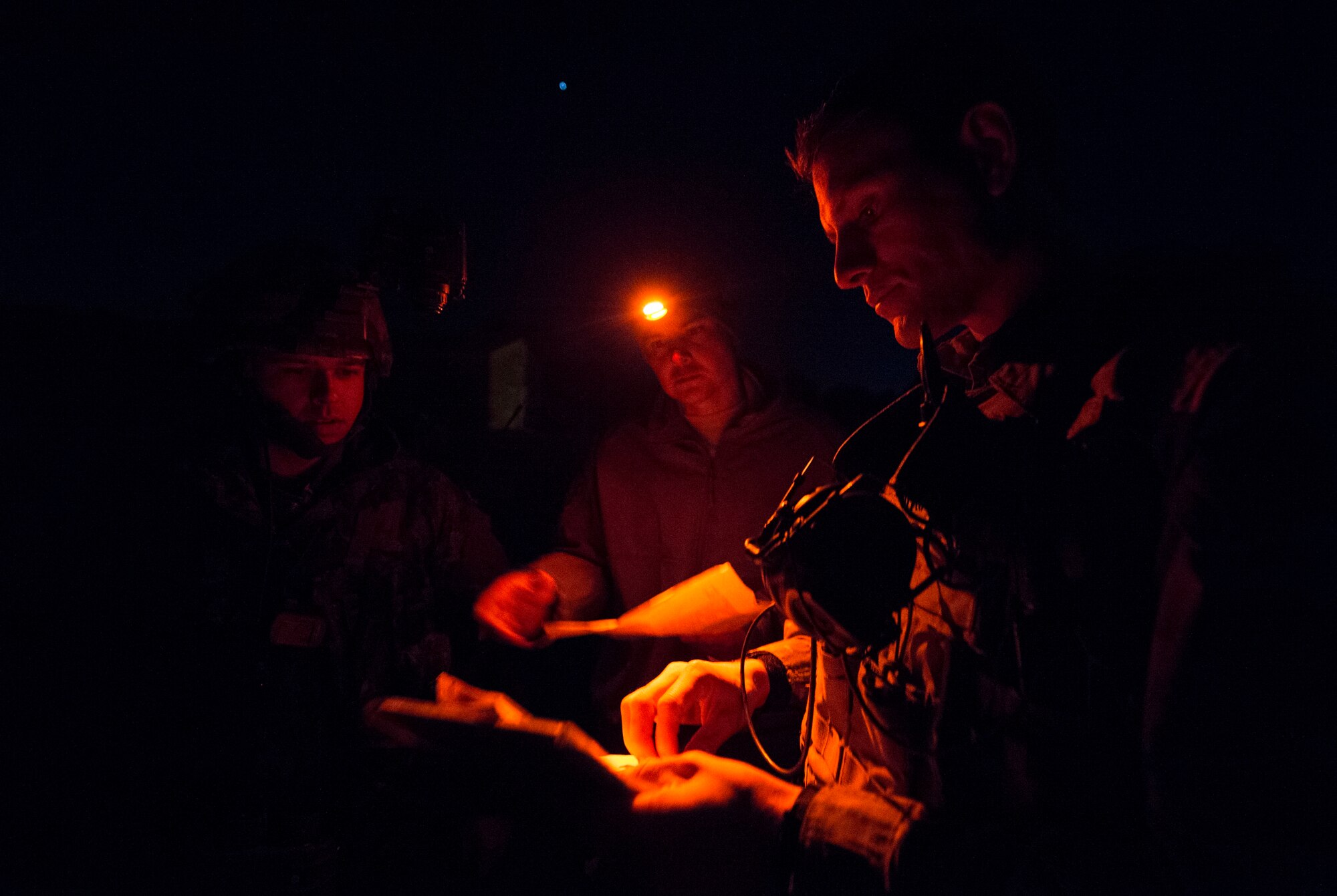 Tech. Sgt. Jeremy Rarang, Senior Airman Tormod Lillekroken, 2nd Air Support Operations Squadron joint terminal attack controllers, and Master Bombardier Mathiew Marcoux-Desrochers, a joint terminal attack controller from the Yankee Battery of the 2nd Regiment, Royal Canadian Horse Artillery, discuss training objectives as part of a night training scenario during Exercise Serpentex ‘16 in Corsica, France, March 15, 2016. Lillekroken grew up in Stange, Norway, and left to live in America when he was 20 years old. He joined the U.S. Air Force three years later to become a part of the tactical air control party career field. (U.S. Air Force photo/Staff Sgt. Sara Keller)