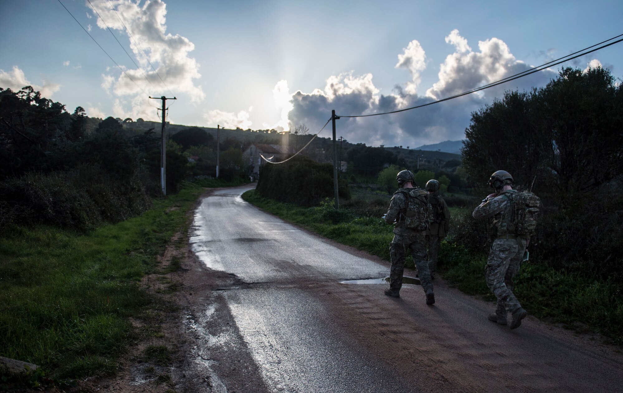 Tech. Sgt. Jeremy Rarang, Senior Airman Tormod Lillekroken and Staff Sgt. Seth Hunt, 2nd Air Support Operations Squadron joint terminal attack controllers, walk along a road as part of a training scenario during Exercise Serpentex ‘16 in Corsica, France, March 15, 2016. JTACs are considered qualified service members who direct the action of air and surfaced-based fires at the tactical level. They are the Airmen on the ground with the authority to control and call in airstrikes on target. (U.S. Air Force photo/Staff Sgt. Sara Keller)