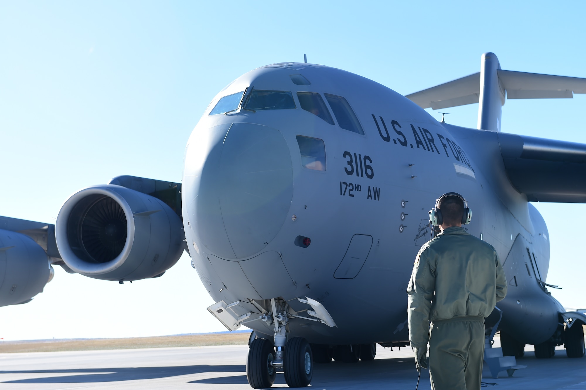 Capt. Canaan Barger, 172nd Airlift Wing co-pilot, inspects the engines of a C-17 Globemaster III March 16, 2016, on Buckley Air Force Base, Colo. The 172 Airlift Wing based at Jackson, Mississippi, is assisting the 140th Wing transport equipment to Tyndall AFB, Florida, for an exercise. (U.S. Air Force photo by Airman 1st Class Luke W. Nowakowski/Released) 
