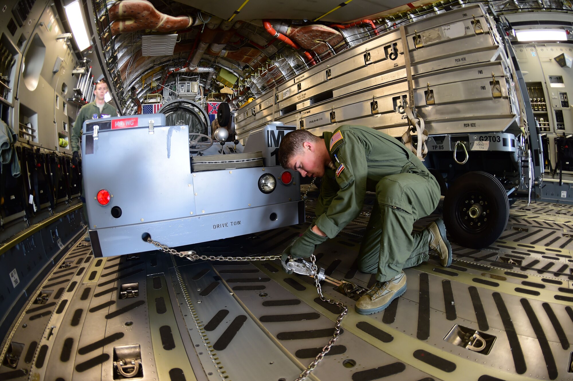 Airman 1st Class Harris Williams, 172nd Airlift Wing loadmaster, locks down cargo in a C-17 Globemaster III March 15, 2016, on Buckley Air Force Base, Colo. The aircraft from the 172nd Airlift Wing, Jackson, Mississippi, helped the 140th Wing transport equipment down to Tyndall AFB, Florida, for an exercise. (U.S. Air Force photo by Airman 1st Class Luke W. Nowakowski/Released) 