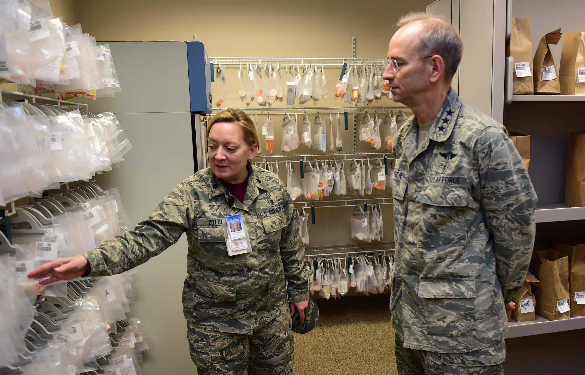 Lt. Gen. (Dr.) Mark A. Ediger, Surgeon General of the Air Force, and Lt. Col. Christina Zotto, officer in charge of the Buckley pharmacy, discuss the new prescription bagging system March 18, 2016, at the Buckley Air Force Base pharmacy, Colo. The pharmacy on base serves military members from all branches, their families and also retirees. (U.S. Air Force photo by Airman 1st Class Gabrielle Spradling/Released)