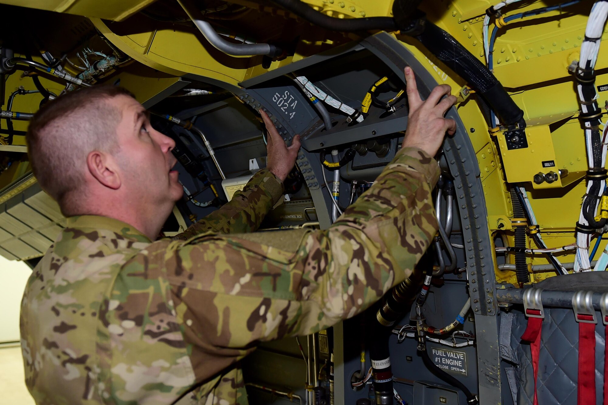 U.S. Army Staff Sgt. Wade Shore, Colorado Army National Guard CH-47 crew chief, displays part of the Chinook helicopter that he is accountable for maintaining March 3, 2016, at the Army Aviation Support Facility on Buckley Air Force Base, Colo. Crew chiefs must maintain the aircraft, crew, load, and passengers’ safety before, during and after flight. (U.S. Air Force photo by Airman 1st Class Gabrielle Spradling/Released)