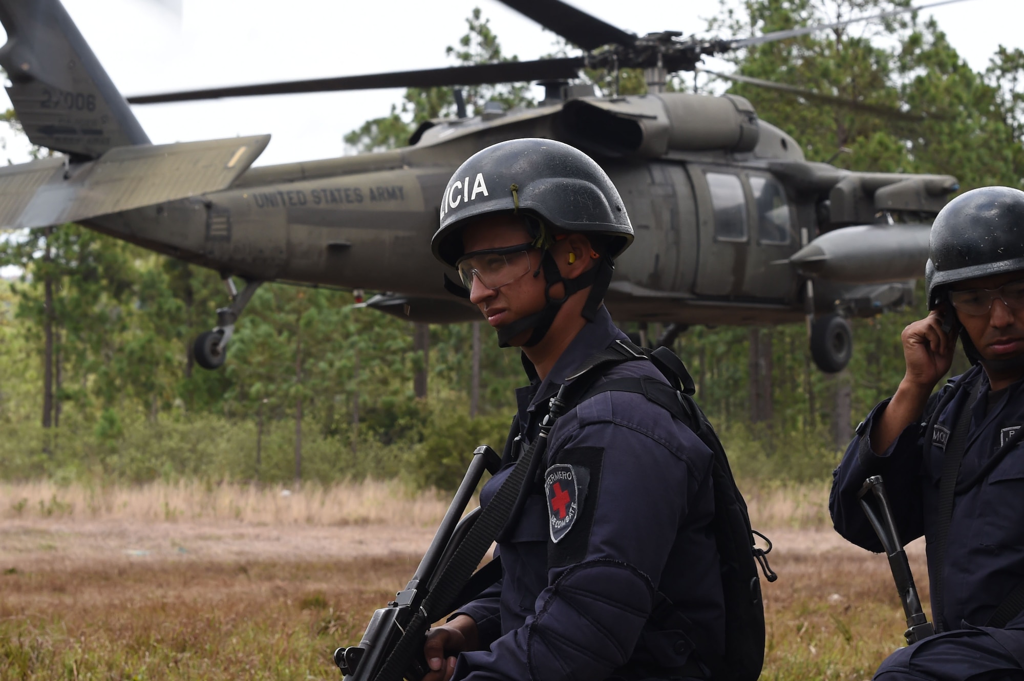Honduran Combat Nurses stand by for instructions during a personnel recovery exercise with U.S. partners from Joint Task Force-Bravo, March 10, 2016 near Soto Cano Air Base, Honduras. During this exercise, the Hondurans integrated with U.S. Servicemembers, providing security to the site while U.S. firefighters and medical personnel practiced recovering simulated victims from a mock helicopter crash. (U.S. Army photo by Martin Chahin/Released) 