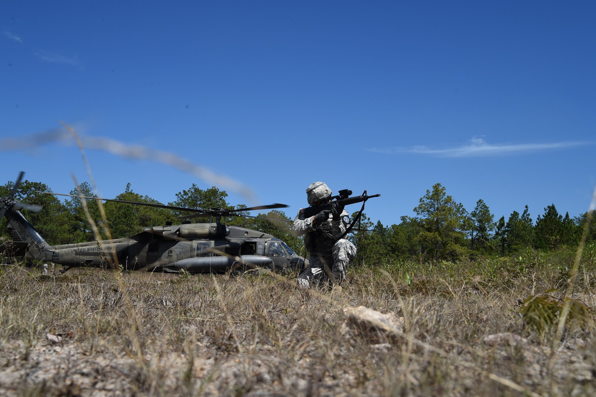 Sgt. Edmanuel Reyes, Joint Task Force-Bravo Joint Security Forces, provides site security for simulated downed aircraft during a personnel recovery exercise involving Servicemembers from JTF-Bravo and Honduran forces, March 10, 2016, near Soto Cano Air Base, Honduras. During this exercise the Honduran forces were able to respond as protective force for responding U.S. personnel, while JSF members secured the simulated downed aircraft. (U.S. Army photo by Martin Chahin/Released)