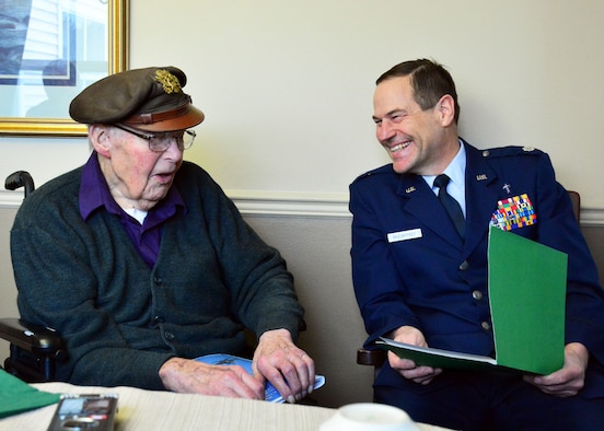 Retired Lt. Col. Leonard Erickson shares his experience as a World War II United States Army Air Forces navigator with 120th Airlift Wing Chaplain, Lt. Col. Arthur McCaffrey, at an assisted living facility in Butte, Mont., March 10, 2016. (U.S. Air National Guard photo by Senior Master Sgt. Eric Peterson/Released)