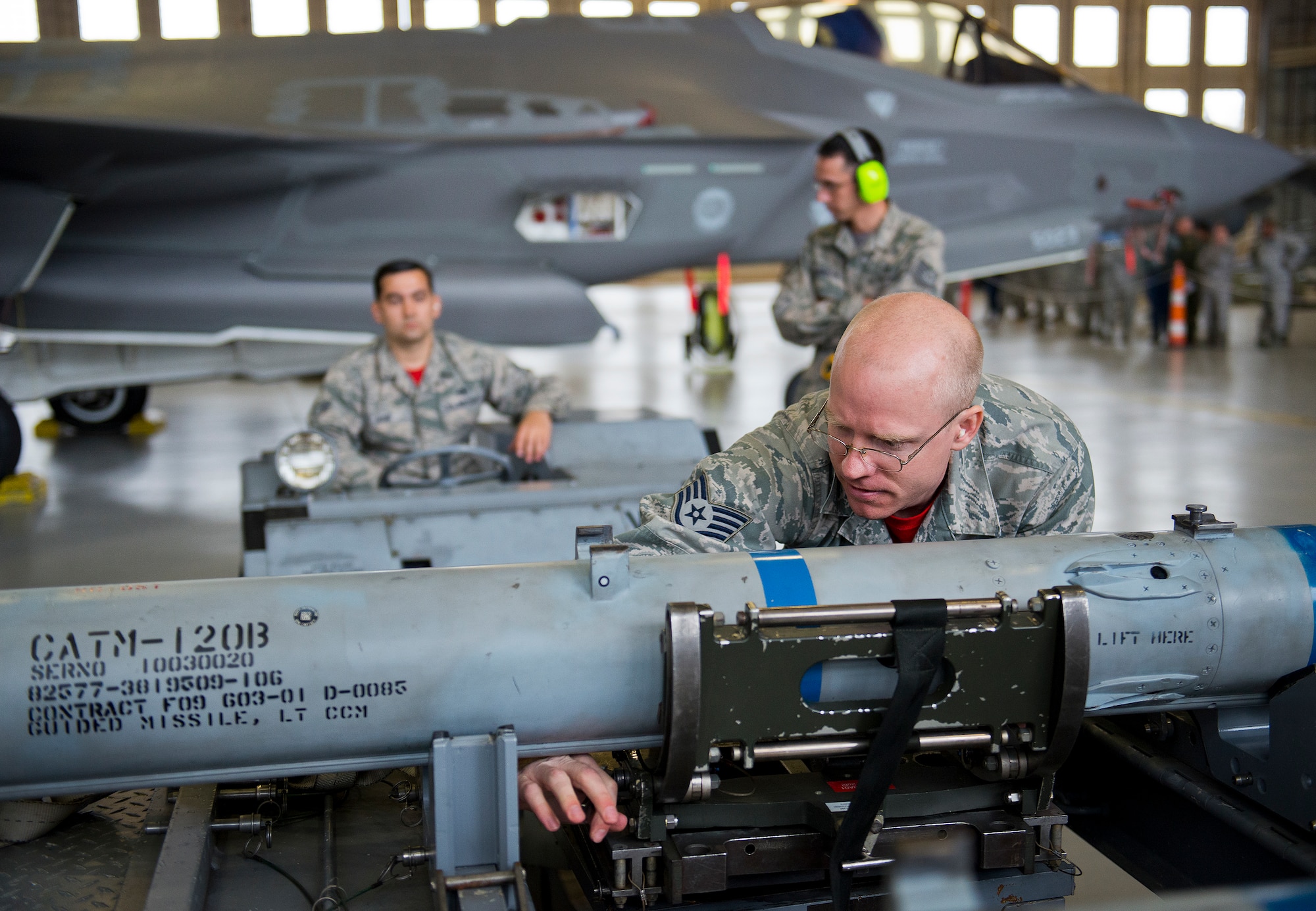 Staff Sgt. Tyler Marking, 96th Aircraft Maintenance Unit Red, prepares an AIM-120 missile to be moved and loaded onto an F-15 Eagle March 18 at Eglin Air Force Base, Fla.  The timed load was part of the first-ever Team Eglin weapons load competition pitting the 33rd Fighter Wing against the 96th Test Wing.  The 33rd FW won the first of what is to become a yearly competition.  (U.S. Air Force photo/Samuel King Jr.)