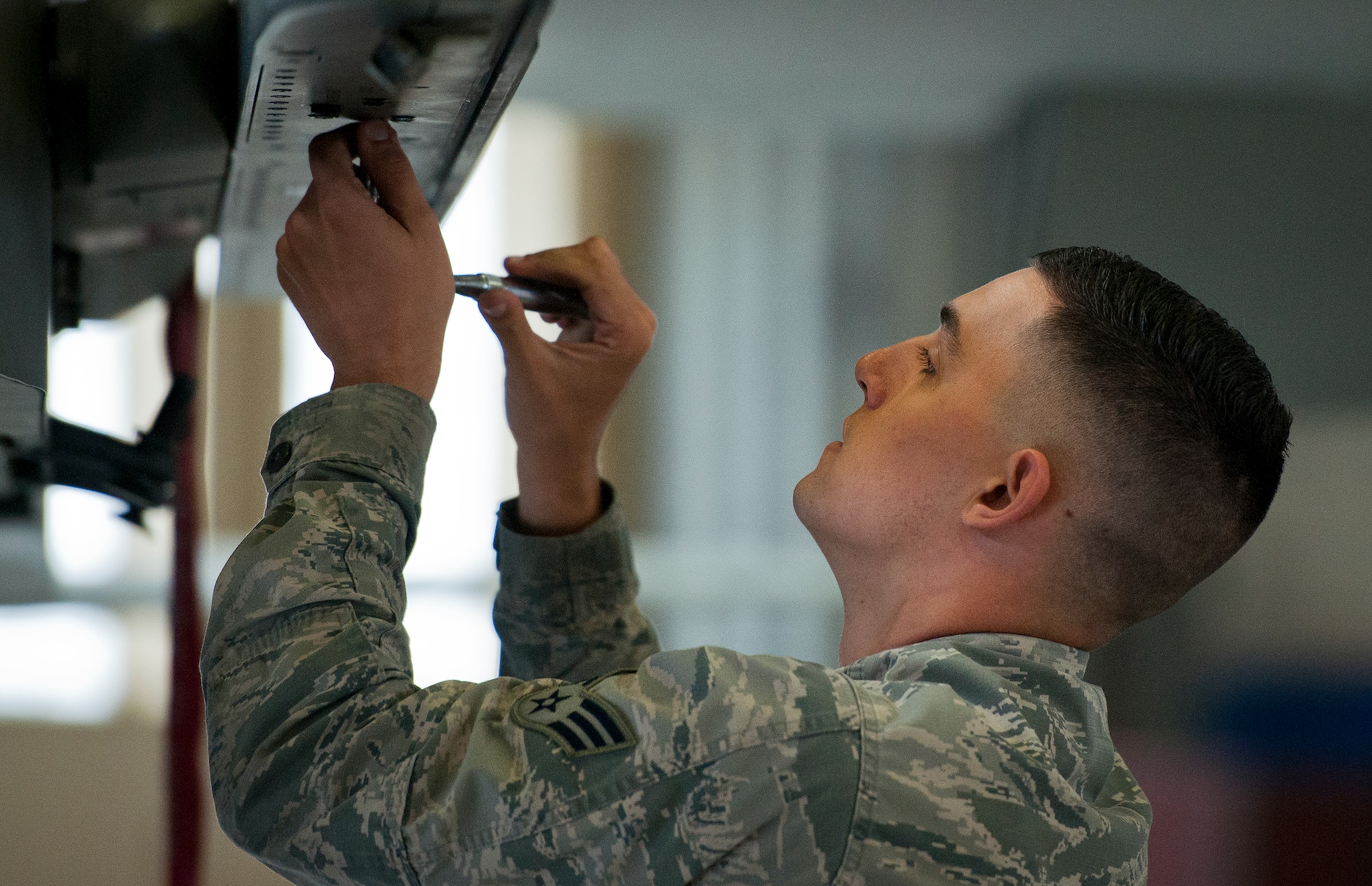 Senior Airman Nicholas Brooks, 96th Aircraft Maintenance Unit Red, prepares his F-15 Eagle for two AIM-120 missiles to be loaded onto its wings March 18 at Eglin Air Force Base, Fla.  The timed load was part of the first-ever Team Eglin weapons load competition pitting the 33rd Fighter Wing against the 96th Test Wing.  The 33rd FW won the first of what is to become a yearly competition.  (U.S. Air Force photo/Samuel King Jr.)