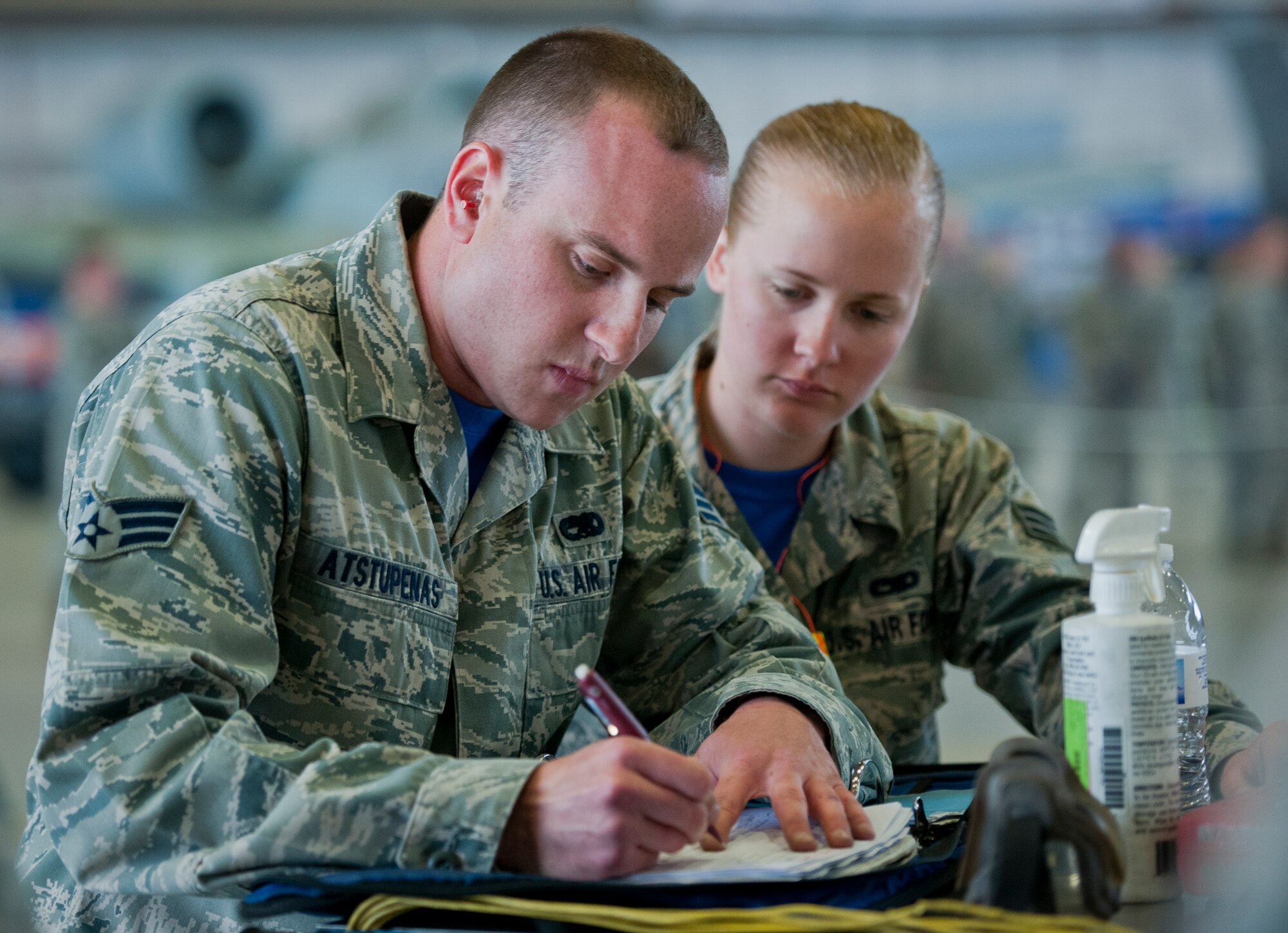 Senior Airman Jonathan Atstupenas, 96th Aircraft Maintenance Unit Blue, marks his checklist after completing a weapons load on an F-16 Fighting Falcon March 18 at Eglin Air Force Base, Fla.  The timed load was part of the first-ever Team Eglin weapons load competition pitting the 33rd Fighter Wing against the 96th Test Wing.  The 33rd FW won the first of what is to become a yearly competition.  (U.S. Air Force photo/Samuel King Jr.)