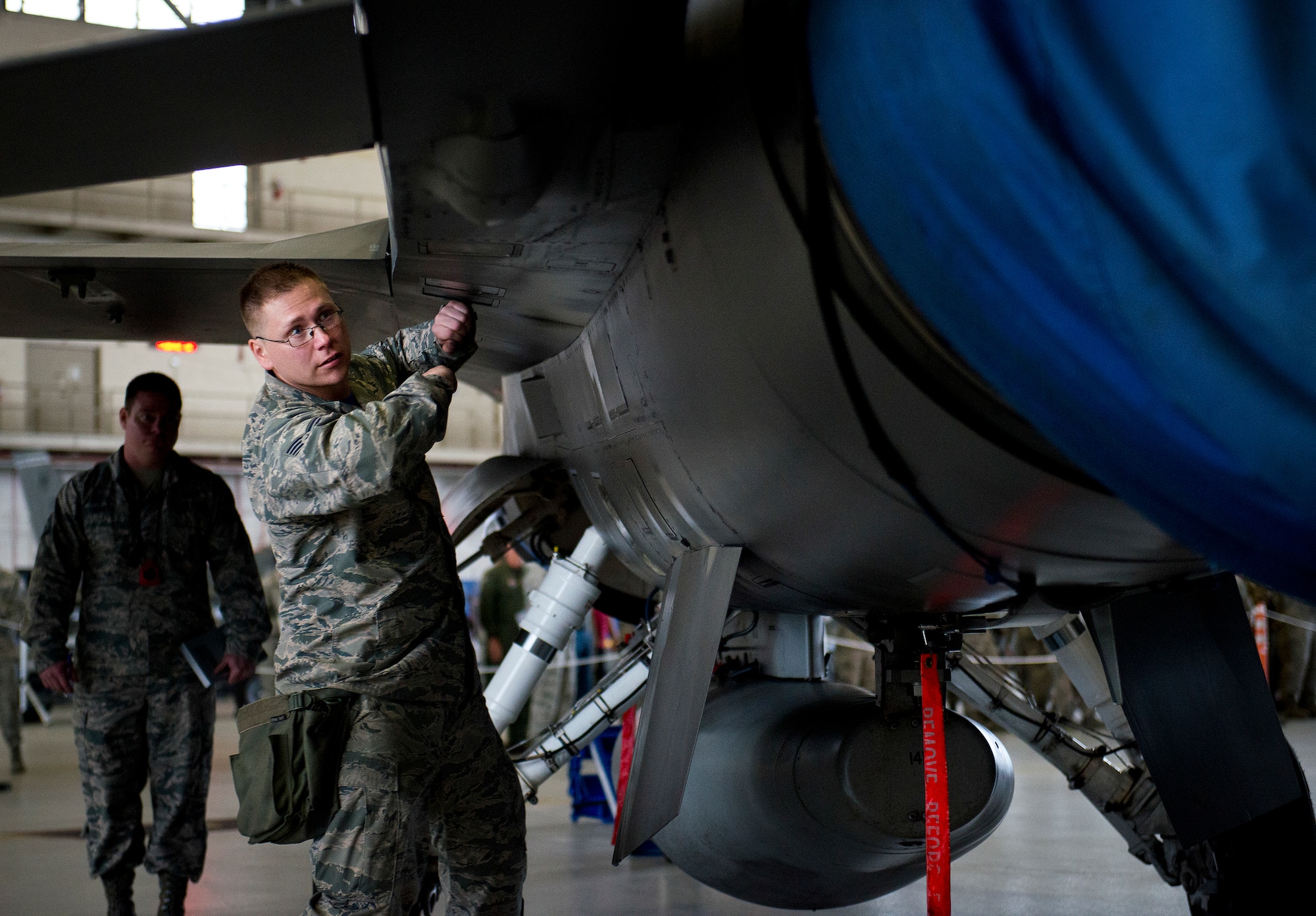 Staff Sgt. Steven Guiette, 96th Aircraft Maintenance Unit Blue, performs checks on his aircraft after his team loaded two AIM-120 missiles onto their F-16 Fighting Falcon March 18 at Eglin Air Force Base, Fla.  The timed load was part of the first-ever Team Eglin weapons load competition pitting the 33rd Fighter Wing against the 96th Test Wing.  The 33rd FW won the first of what is to become a yearly competition.  (U.S. Air Force photo/Samuel King Jr.)