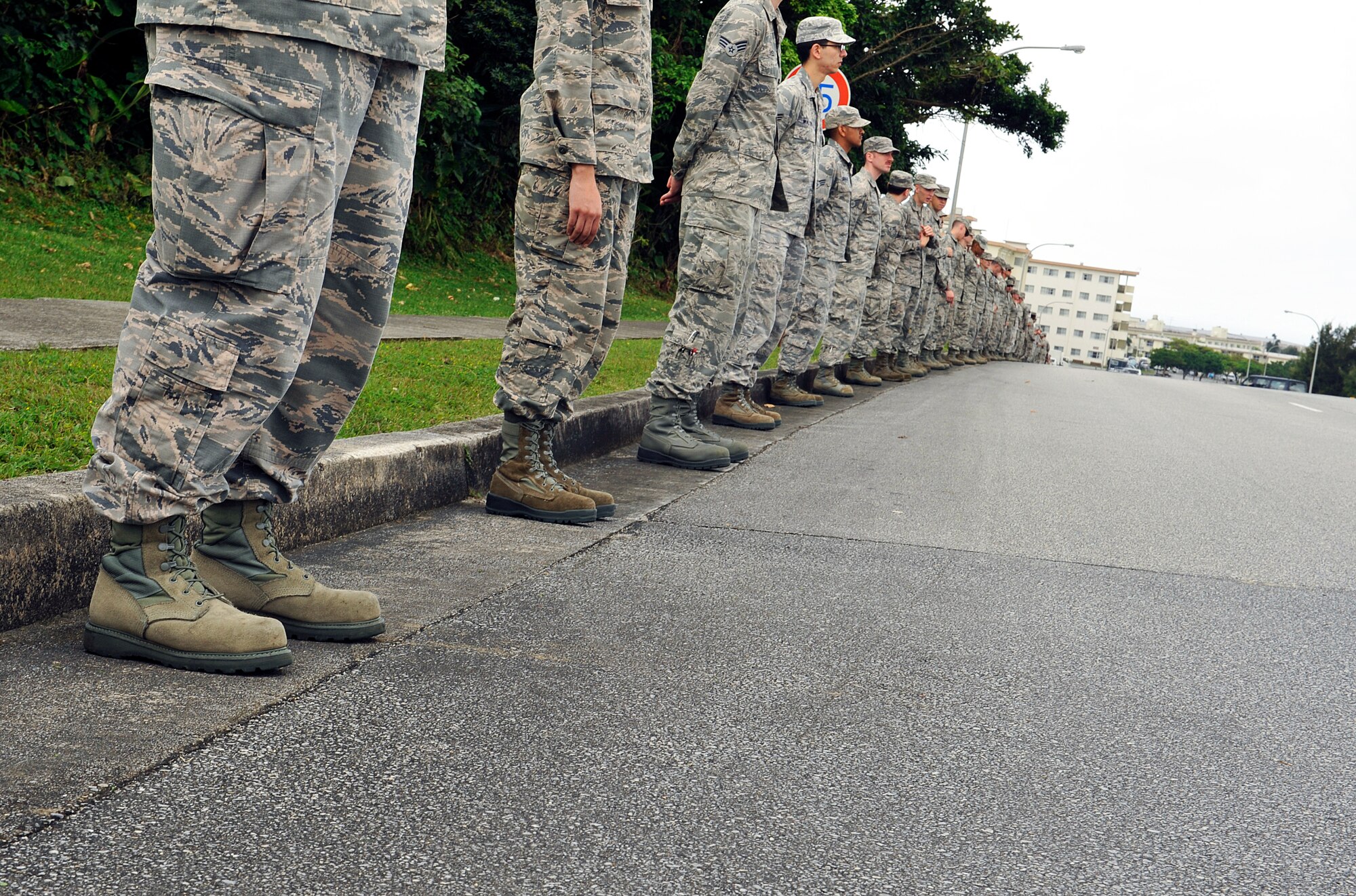 Members from the 18th Maintenance Group line up along the road during Jack Oshiro's memorial procession, March 18, 2016, at Kadena Air Base, Japan. Team Kadena paid tribute to Oshiro's legacy and contributions to the community over the last 60 years. (U.S. Air Force photo by Naoto Anazawa)
