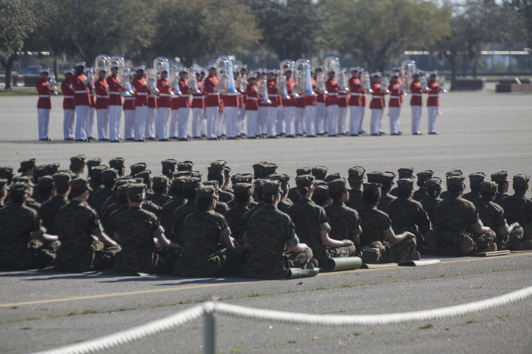U.S. Marine Corps recruits with 4th Recruit Training Battalion, attend the performance of the Commandants own Drum and Bugle Corps at the Peatross parade deck on Marine Corps Recruit Depot, Parris Island, S.C., on Mar. 15, 2016. The Drum and Bugle Corps, Silent Drill Platoon and Marine Corps Color Guard perform annually on Parris Island. (U.S. Marine Corps photo by Lance Cpl. Richard Currier/Released)