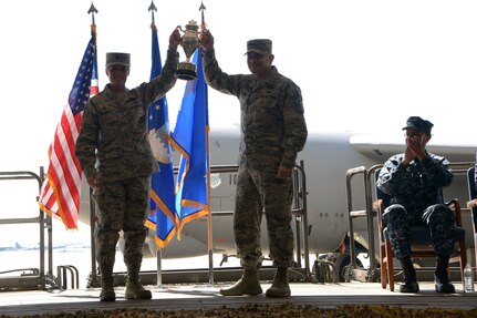 U.S. Air Force Col. Kristin Goodwin, 2nd Bomb Wing commander (left), and U.S. Air Force Chief Master Sgt. Tommy Mazzone, 2nd Bomb Wing command chief master sergeant (center), hold up the Omaha Trophy during an award ceremony honoring the 2nd Bomb Wing at Barksdale Air Force Base, La., March 21, 2016. During the ceremony, U.S. Navy Adm. Cecil D. Haney, U.S. Strategic Command (USSTRATCOM) commander (right), and Mr. W. Gary Gates (not pictured), Strategic Command Consultation (SCC) Committee member, presented the 2015 Omaha Trophy, strategic bomber category, to Goodwin and Mazzone in recognition of the wing's contributions to USSTRATCOM's global strategic missions. The Omaha Trophy, which dates back to the U.S. Air Force's Strategic Air Command, was originally created by the SCC in 1971. At the time, a single trophy was presented annually as a token of appreciation to USSTRATCOM's best wing. Since then, the tradition has evolved to unit-level awards that recognize the command's premier intercontinental ballistic missile (ICBM) wing, ballistic missile submarine, strategic bomber wing and global operations (space/cyberspace) unit. This year, a new category was added to include the combatant command's top strategic aircraft wing. (U.S. Air Force photo by Staff Sgt. Joseph A. Pagan Jr.) Story Available: https://www.stratcom.mil/news/2016/595/-/