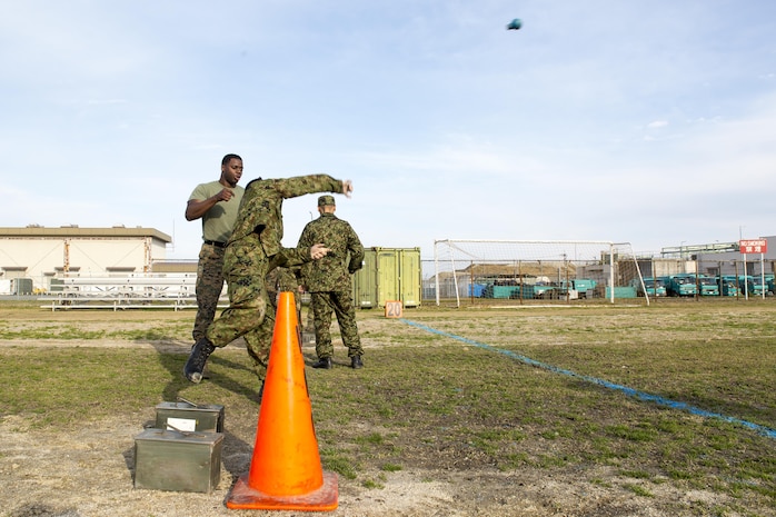 Japan Ground Self-Defense Force Sgt. 1st Class Iwamoto, Japanese interpreter instructor, throws a rubber grenade while conducting a combat fitness test during the Public Affairs Office’s annual English seminar on Marine Corps Air Station Iwakuni, Japan, March 16, 2016. The seminar is held annually by the station Public Affairs Office to help improve upon the JGSDF’s understanding and use of the English language prior to their deployment in support of exercises in both the United States and Japan.  (U.S. Marine Corps photo by Sgt. Antonio J. Rubio/Released)