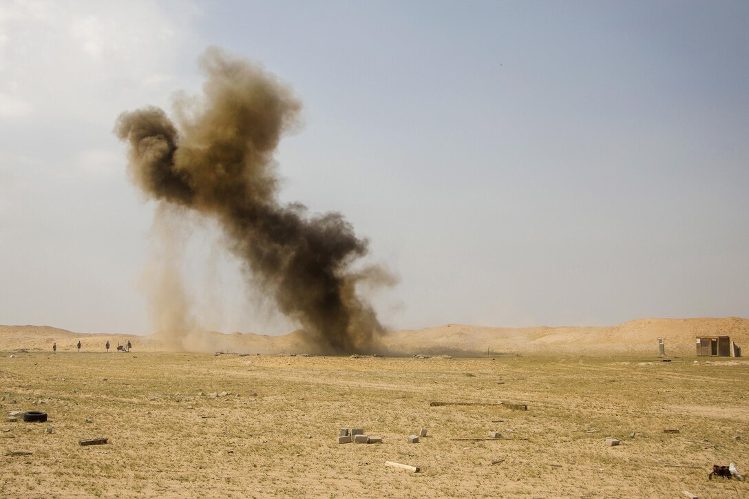 Smoke and dust rise into the sky after Marines detonated an explosive during a demolition training event at a range in Southwest Asia, March 9, 2016. Marine Corps photo by Cpl. Akeel Austin