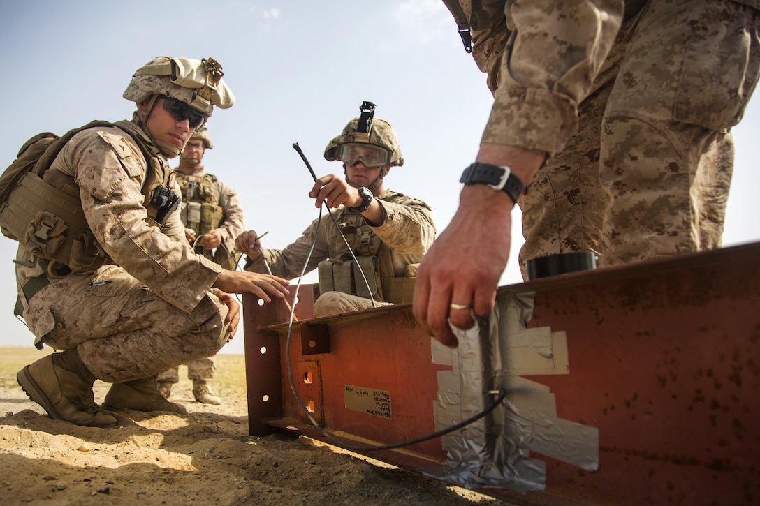 Marines place composition C-4 explosive on an I-beam during a demolition training range in Southwest Asia, March 9, 2016. Marine Corps photo by Cpl. Akeel Austin