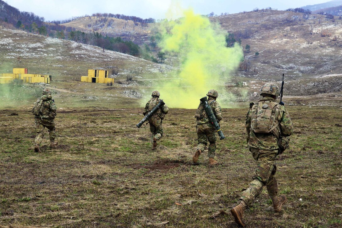 U.S. soldiers advance forward toward their next objective under the cover of smoke during a live-fire exercise as part of Exercise Rock Sokol at Pocek Range in Postonja, Slovenia, March 9, 2016. Army photo by Paolo Bovo