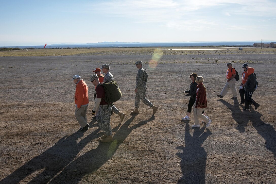 Retired Army Col. Ben Skardon, left, walks across the high New Mexico desert of the White Sands Missile Range during the Bataan Memorial Death March, March 20, 2016. Army photo by Staff Sgt. Ken Scar