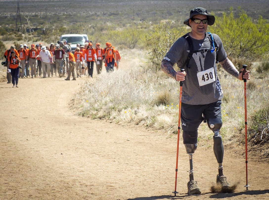 Harold Bologna, a former Navy special operations master chief, walks ahead of retired Army colonel and Bataan Death March survivor Ben Skardon during the Bataan Memorial Death March at White Sands Missile Range, N.M., March 20, 2016. Army photo by Staff Sgt. Ken Scar