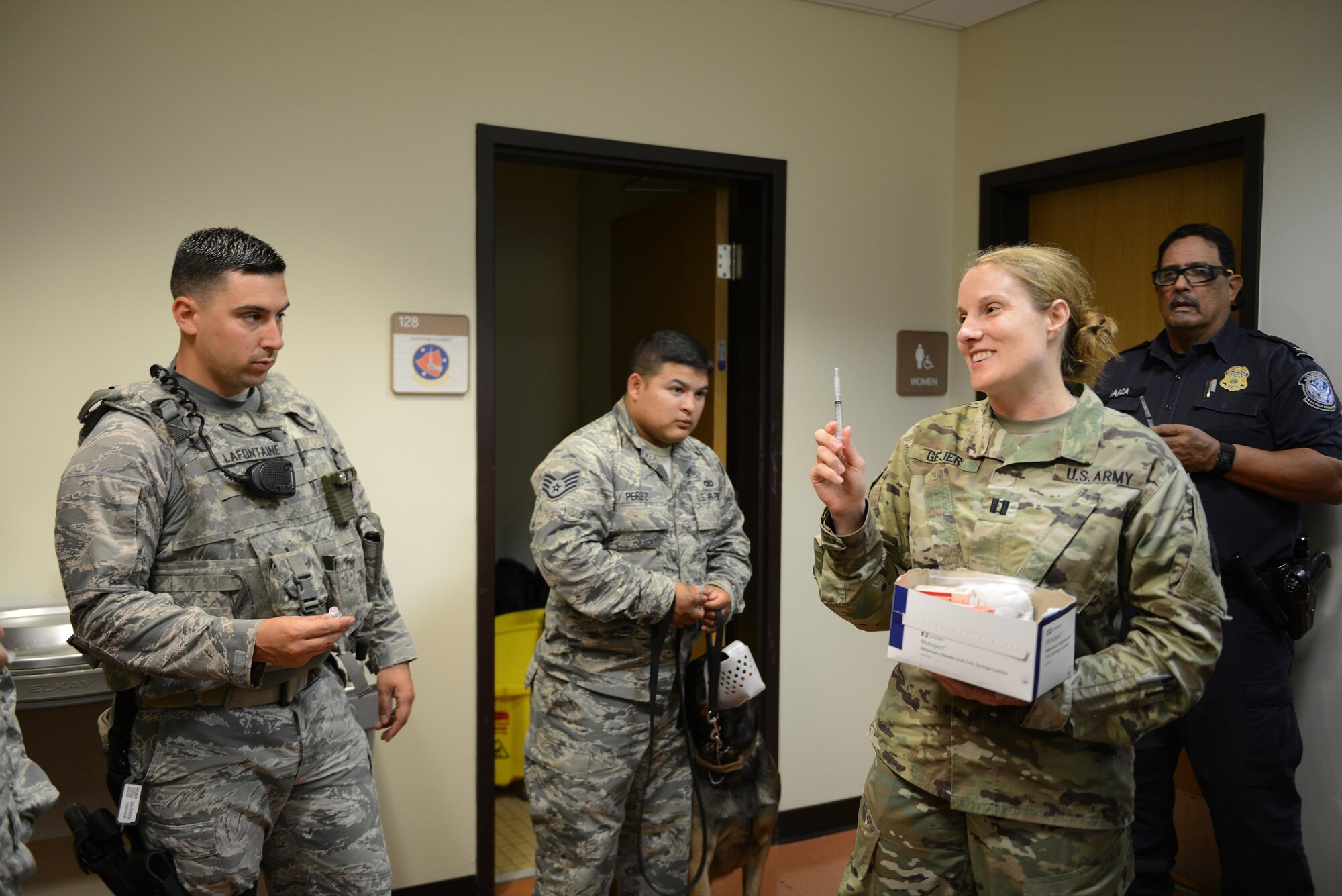 Army Capt. Ambre Gejer, South Texas Branch Veterinary Services chief, demonstrates how to “break the seal” on a syringe with one hand on Laughlin Air Force Base, Texas, Mar. 9, 2016. Members of the Army Veterinarian Corps visited Laughlin to train Air Force and U.S. Customs and Border Protection military working dog handlers. (U.S. Air Force photo by Senior Airman Jimmie D. Pike)