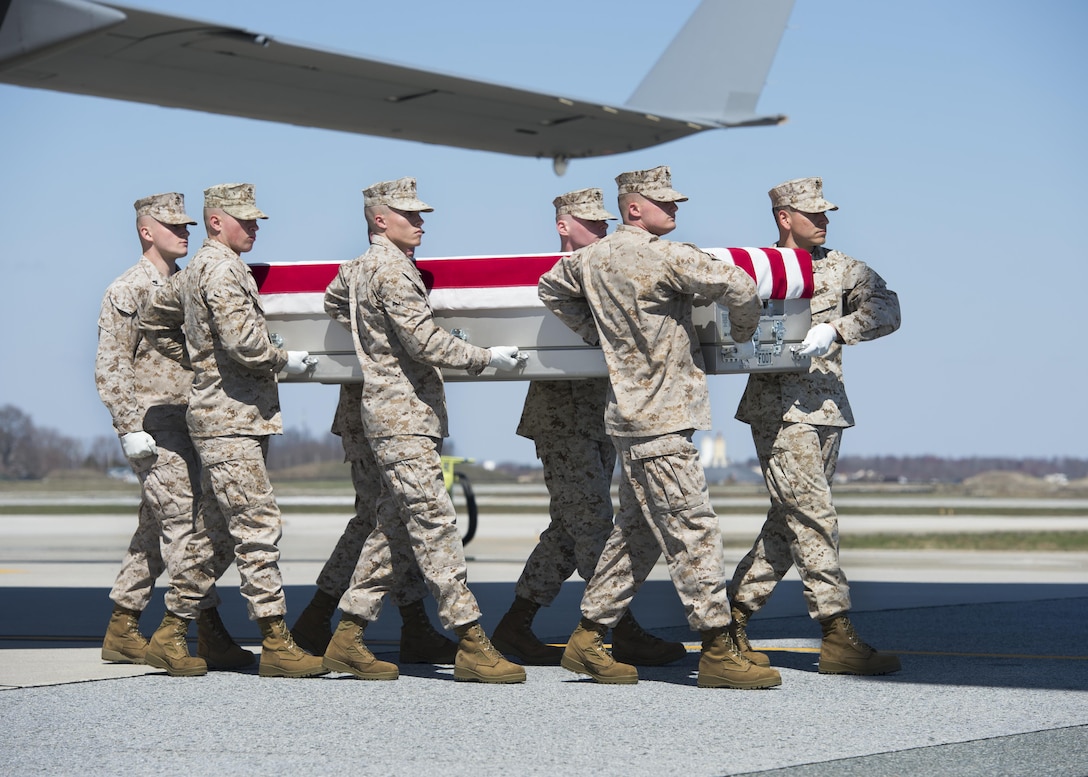 Marines from A Co., Marine Barracks Washington, D.C., transfer the remains of Staff Sgt. Louis F. Cardin, of Temecula, Calif., during a dignified transfer March 21, 2016, at Dover Air Force Base, Del. Cardin was assigned to the 2nd Battalion, 6th Marine Regiment, 26th Marine Expeditionary Unit, Cap Lejeune, N.C. (U.S. Air Force photo/Senior Airman Class Zachary Cacicia)