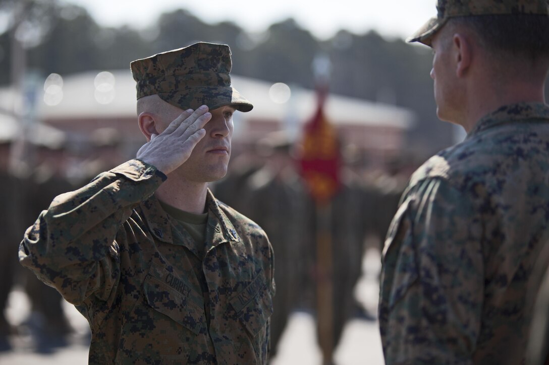 Cpl. Joseph Currey, left, salutes Lt. Col. Jeremy Winters, right, during an award ceremony at Marine Corps Air Station Cherry Point, N.C., March 1, 2016. Currey was awarded the Navy and Marine Corps Commendation Medal for his actions after witnessing an ambulance wreck. Currey demonstrated his devotion to serving others as he placed the well-being of the injured personnel above his own by running towards the scene of an accident and rendering aide to those need. Currey is an air support operations operator with Marine Aviation Support Squadron 1. (U.S. Marine Corps photo by Cpl. Austin A. Lewis, U.S. Marine Corps caption by Cpl. N.W. Huertas/Released)
