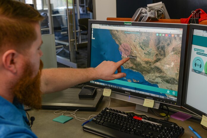 Buddy Steshka, a technical support specialist at ManTech International Corporation, explains a program created by a Marine Corps Intelligence Surveillance Reconnaissance Enterprise Accelerator team. The program is being used to help intelligence Marines do their job.