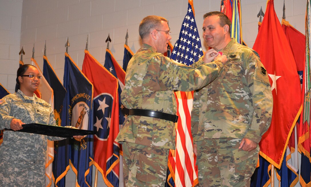 Brig. Gen. Steven W. Ainsworth, the 94th Training Division commander, awards the Legion of Merit to Command Sgt. Maj. Arlindo Almeida, the outgoing command sergeant major, for his time as the division’s senior noncommissioned officer. Almeida transferred his responsibilities to Command Sgt. Maj. Sharon Campbell making her the division’s first command sergeant major during a change of responsibility ceremony at Fort Lee Va., March 18, 2016.