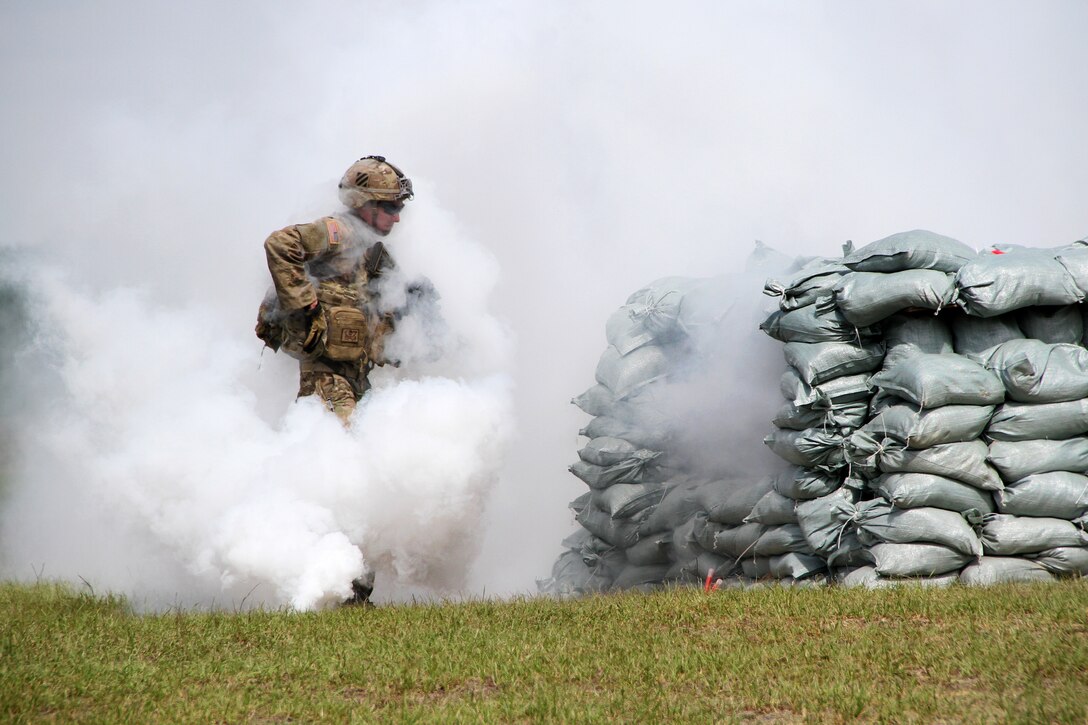 A soldier moves under the cover of smoke to clear a bunker during a training exercise at Fort Stewart, Ga., March 10, 2016. The soldier is assigned to the 3rd Infantry Division’s Company B, 2nd Battalion, 7th Infantry Regiment, 1st Armored Brigade Combat Team. Army photo by Pfc. Payton Wilson