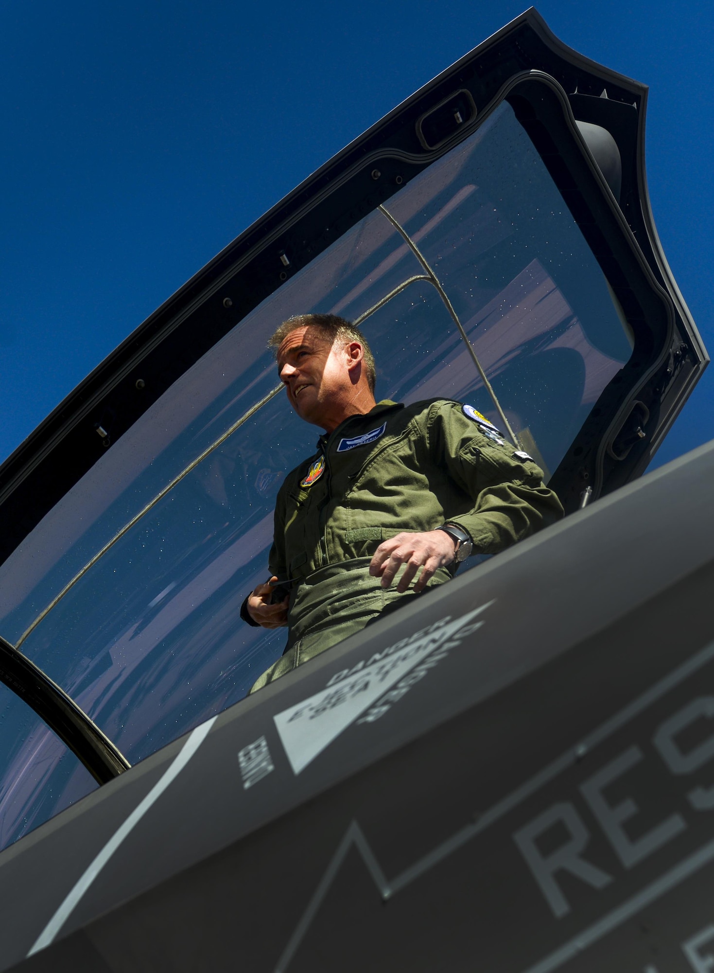 Maj. Gen. Jay Silveria, United States Air Force Warfare Center commander, looks out of the cockpit of an F-35A Lightning II at friends and family after his final flight at Nellis Air Force Base, Nev., March 10, 2016. A fini flight is a pilot's last flight in the aircraft before he/she leaves a squadron, a wing, or retires from the Air Force. (U.S. Air Force photo by Airman 1st Class Kevin Tanenbaum)