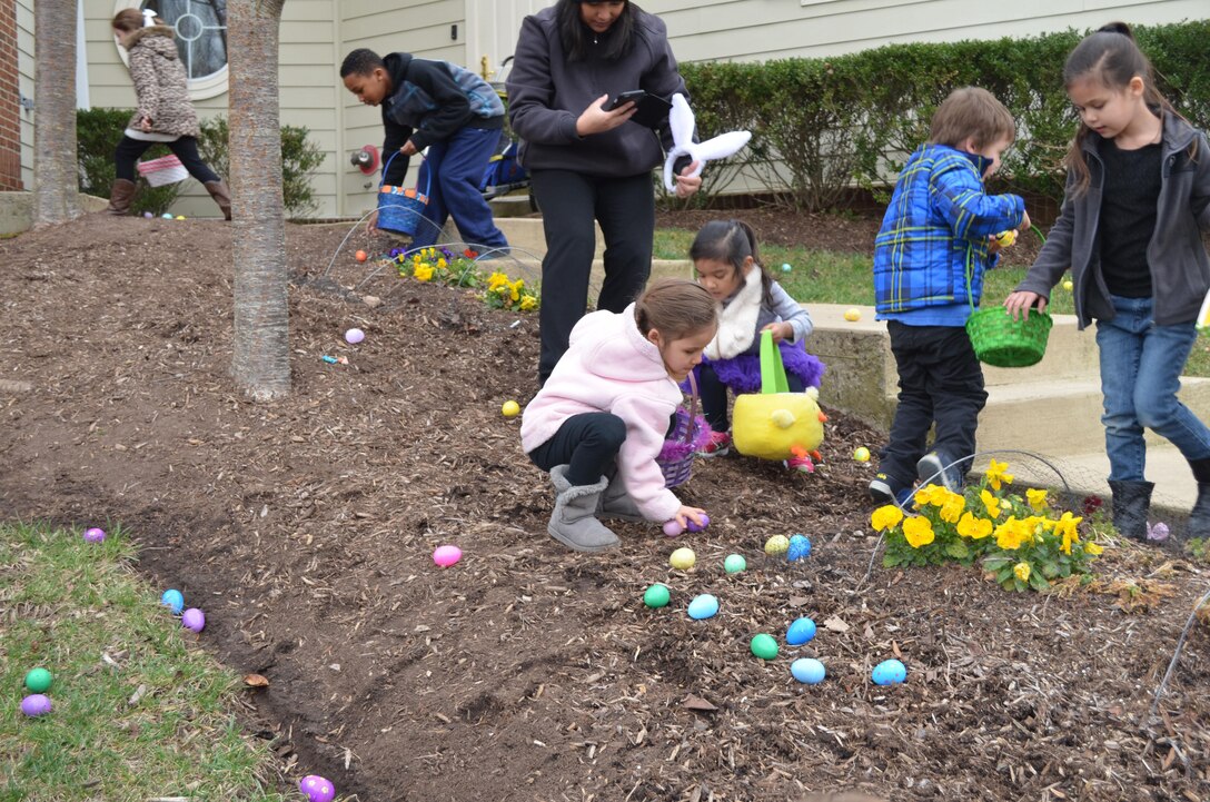 MARINE CORPS BASE QUANTICO, Va. — Children pick up eggs in the garden at the Lincoln Military Housing office during the 2016 Easter Egg Hunt. 