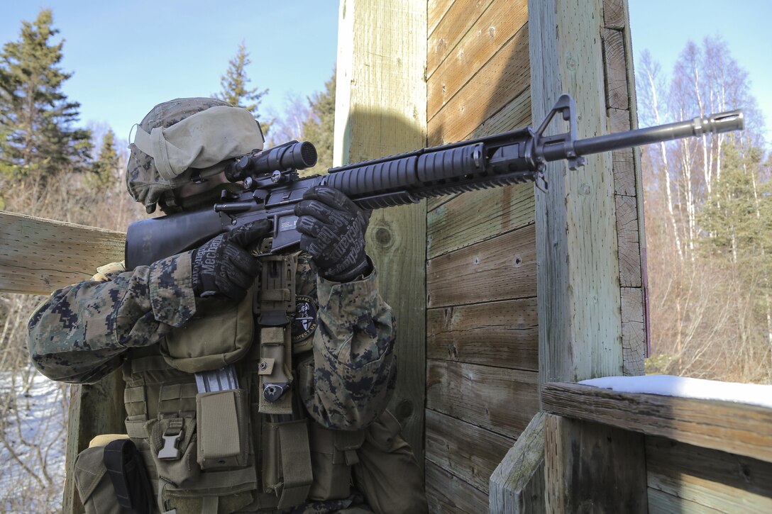 Marine Corps Lance Cpl. Matthew Rogers provides security while members of his team clear a complex during urban operations training on Joint Base Elmendorf-Richardson, Alaska, March 6, 2016. Rodgers is assigned to Detachment Military Police, Delta Company, 4th Law Enforcement Battalion. Air Force photo by Alejandro Pena

