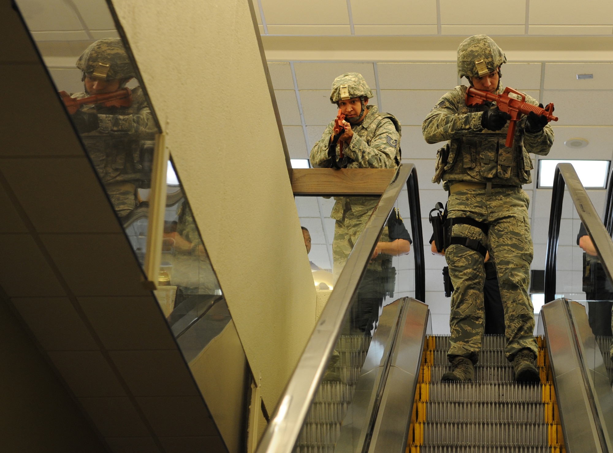 Tech. Sgt. James Herrera, 81st Security Forces Squadron operations NCO in charge, and Staff Sgt. Cody Berry, 81st SFS ?, survey the area for gunmen during Keesler's active shooter exercise at the Keesler Medical Center Mar. 17, 2016, Keesler Air Force Base, Miss.  An active duty Air Force member simulated opening fire at the hospital to test the base's ability to respond to and recover from a mass casualty event. (U.S. Air Force photo by Kemberly Groue)