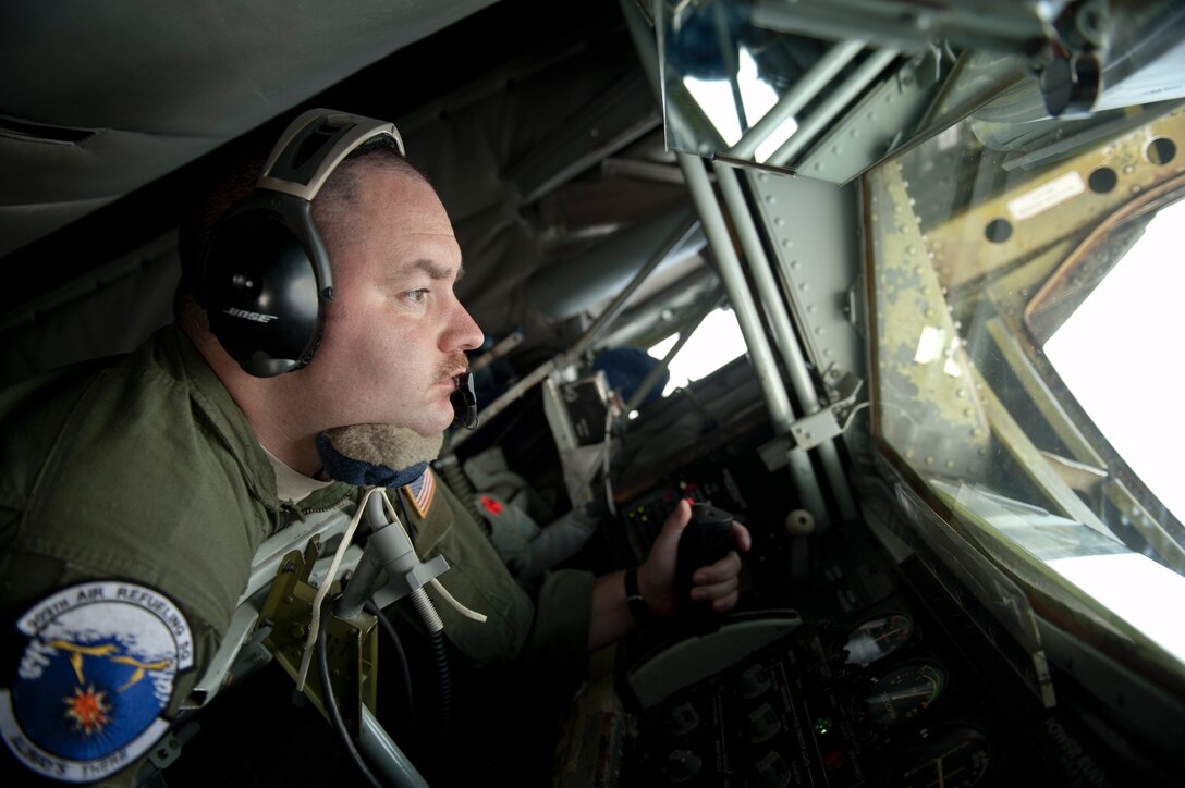 U.S. Air Force Staff Sgt. David Ballmer, 909th Air Refueling Squadron boom operator, performs an inflight refueling procedure, March 21, 2016, off the coast of Japan. Specially trained aircrews from the 909th ARS provide around-the-clock tanker support for U.S. and coalition forces, enabling asset and theater protection throughout the Indo-Asia-Pacific region. (U.S. Air Force photo by Senior Airman Peter Reft/Released)